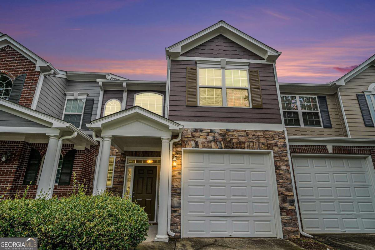 Welcome to 2731 Pierce Brennen Court - where comfort meets convenience in this beautifully updated townhome located in the sought-after Olde Peachtree Townhomes community of Lawrenceville! This move-in-ready 3-bedroom, 2.5-bathroom home boasts a classic brick and stone front with a 1-car garage and covered entry. Inside, you'll find fresh paint, new carpet, and hardwood flooring throughout the main level. The spacious living room features a cozy gas fireplace and plantation shutters that allow natural light to pour in. The open-concept kitchen is perfect for cooking and entertaining, featuring rich wood cabinetry, a center island, sleek black appliances, and modern pendant lighting. The dining area opens to a private patio ideal for relaxing or grilling out. Upstairs, the oversized owner's suite includes vaulted ceilings, a walk-in closet, and a bathroom with dual vanities, a soaking tub, and a separate shower. And the upstairs laundry area adds extra convenience. Located in the quiet and well-maintained Olde Peachtree Townhomes subdivision, residents enjoy low HOA fees that cover landscaping, exterior maintenance, and more. This peaceful neighborhood is minutes from I-85, Coolray Field, Mall of Georgia, and top Gwinnett County schools-including Rock Springs Elementary and Collins Hill High School. Don't miss your opportunity to own this spacious townhome in a prime Lawrenceville location-close to everything, yet tucked away in a serene community!