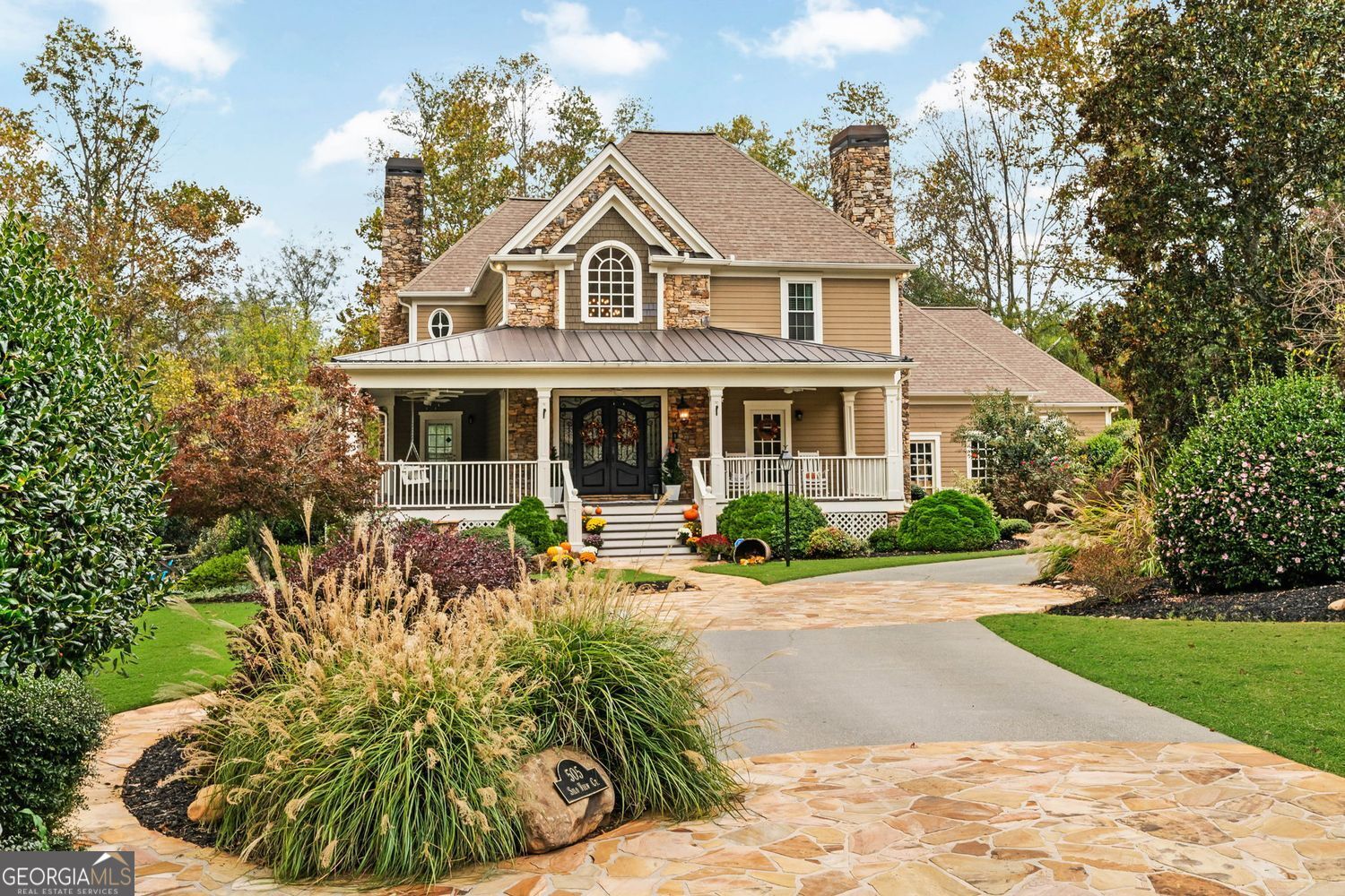 Discover Bradshaw Farms best keep secret in this amazing Estate Style nestled on 1.49 acres at the end of a private cul-de-sac and backs to your own private oasis surrounded by golf course on Red Course #1 green and Red #2 fairway. This is not just a house, this is a home. This is Southern living at its finest in this grand style home with a true wrap around front porch. You will fall in love with this home from the moment you enter the spectacular custom double doors that opens to the welcoming two story foyer, curved staircase and warm, inviting hardwood flooring that flows through most main living areas. This home embodies timeless elegance and modern comfort, all in a setting worthy of lingering good nights and sunlit mornings. Home features three full kitchens, a full finished basement, in-ground pool and storage galore. The private carriage house apartment adds charm and includes a two car garage. Beautiful formal living room with fireplace, leads to gorgeous oversized formal dining room. The coffered-ceiling family room with a stacked-stone fireplace, built-in shelving, and full-height windows that overlook your private oasis backyard. The updated chef's kitchen features quartz countertops, a six-burner gas range with custom vent hood, subway tile backsplash, a large center island, stainless steel appliances, walk-in pantry, and a butler's pantry. Just off the kitchen is the light bright breakfast nook with shiplap walls, wraparound windows, and a double tray ceiling with coffered detailing, a perfect place to start the day. The main-level primary suite is a private luxurious retreat. A double tray ceiling crowns the spacious bedroom that includes a sitting room or office, private access to the back deck, and a spa-inspired en suite bathroom with dual vanities, a jetted soaking tub, a walk-in tiled shower with dual shower heads,  oversized walk-in closet with direct access to the laundry room. The beautiful winding staircase leads to the upstairs that offers three large bedrooms and two full baths, The finished lower level is a full living space of its own, complete with two flex rooms currently used as bedrooms, a full bath, a second kitchen, a game room, a theater room, and a cozy third fireplace. This level opens out to the backyard and covered patio. Outside you'll find a dream backyard that reaches new heights and built with no detail overlooked for outdoor living and enjoyment for every season, fully fenced and professionally landscaped. A gunite in-ground pool  includes a full outdoor kitchen, firepit, and gazebo with a centerpiece fireplace, creating the ultimate space to gather or unwind. The detached carriage house offers even more,  a full kitchen, living area/bedroom, laundry and bathroom, ideal for guests, extended stays, or extra income potential. This estate combines superb architectural details, lush grounds and the tranquility to let you enjoy all this home has to offer.  Bradshaw Farm amenities can't be beat, You will enjoy access to multiple pools, tennis courts, pickleball, volleyball, basketball, a clubhouse, and playgrounds, with an amazing Golf course, all in one of Woodstock's most desirable neighborhoods.