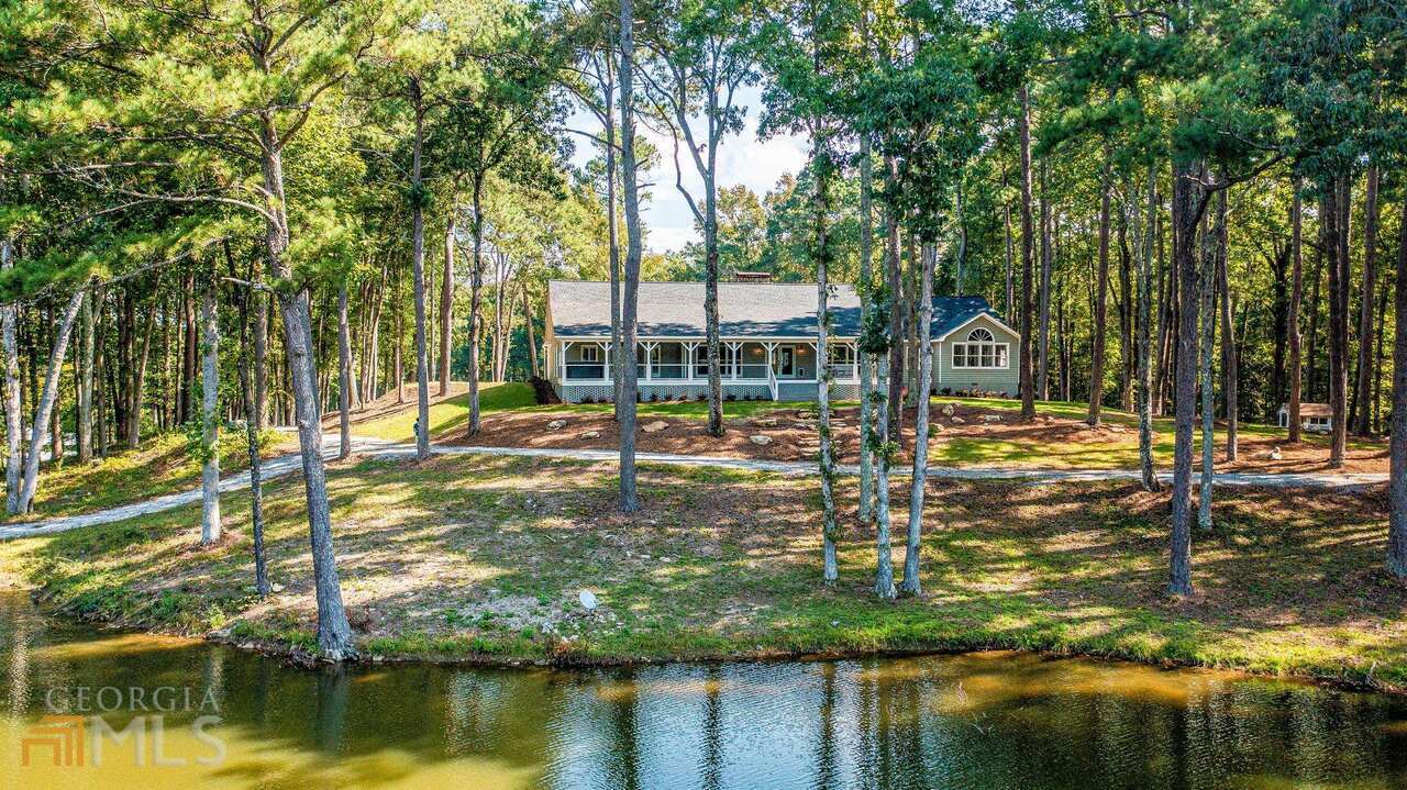 THE ULTIMATE TRANQUIL ESTATE PROPERTY! Beautiful 108 acres, two lakes, newly renovated 4,000 sq ft ranch home, separate guest/caretaker chalet, barn and 6 car garage. Nestled away from the hustle and bustle, yet only a 5 minute drive to Trilith studios this is an unbelievable location. The sky is the limit for uses as this estate would make the perfect family compound and retreat, second home or vacation get away. The moment you step onto the front porch overlooking the lake, experience the Zen atmosphere while watching the deer, Heron and wildlife. The main residence has been totally renovated to an open concept plan with vaulted/beamed great room and lodge style fireplace. Unbelievably gorgeous kitchen. It also includes a separate in-law suite/apartment on the main level with a complete new kitchen. The chalet/carriage house has also been totally renovated. Current owner has made extensive improvements to the properties as well as the land. New roofs, New HVACs, new septic, new well pumps and much more. Enjoy 4 wheeling or walking the trails throughout the property which features a picturesque mill with working waterwheel and a log cabin circa 1700s. Must see to appreciate the beauty of it all! Close to Atlanta, the airport, the interstate and the film studios. View the virtual tour for more!