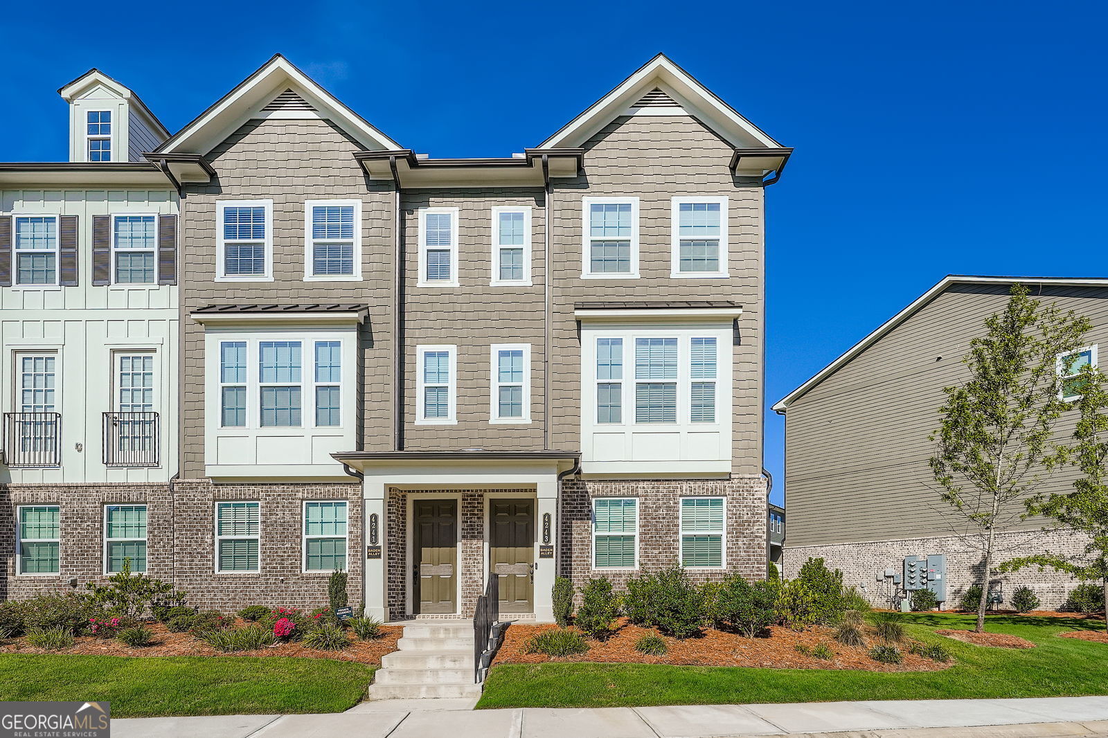 Welcome to this beautifully designed 3-bedroom, 3.5-bathroom townhome offering the perfect blend of comfort, style, and functionality. This open-concept home features a spacious kitchen with white cabinets, gleaming quartz countertops, a large island, and stainless steel appliances - all with a clear view into the inviting family room, ideal for entertaining or everyday living. Hardwood floors run throughout the main level, where oversized windows flood the space with natural light. Each bedroom includes its own private bathroom, providing ultimate convenience and privacy for all residents or guests. Retreat to the expansive master suite, complete with a luxurious en-suite bath featuring a double vanity and a sleek walk-in shower. With thoughtful design across all three levels, this home checks all the boxes for comfort, space, and style.