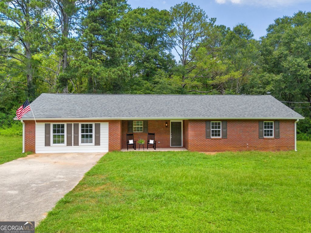 Welcome HOME! Nestled in the charming town of Oxford, this fully renovated 4 sides brick, ranch home offers the best of Southern living. BRAND NEW Modern farmhouse renovations, TOP to bottom!! With 4 bedrooms and two full baths, this single-level brick residence features a welcoming rocking chair porch, perfect for enjoying sweet tea on lazy afternoons. HUGE 1 ACRE private lot, with NO HOA! Inside, discover modern upgrades, including gorgeous gold light fixtures throughout. Gorgeous NEW wood laminate floors and plush new carpet create the most inviting living spaces. The heart of the home is a stunning kitchen with oversized quartz countertops and a spacious entertaining island, stainless appliances, walk in pantry, TONS of cabinetry with brushed gold fixtures. Your 4th flex room provides plenty of space for an office, game room or even guest suite. This open floor plan connecting the dining and family rooms, is ideal for family gatherings. Experience the charm of small-town living with convenient access to the BEST shopping and amenities just 10 minutes to Covington and 10 minutes to Walnut Grove/Loganville. Adored Newton County school district!! Ask us about our DOWN PAYMENT assistance on this property, time to make you a HOMEOWNER!!