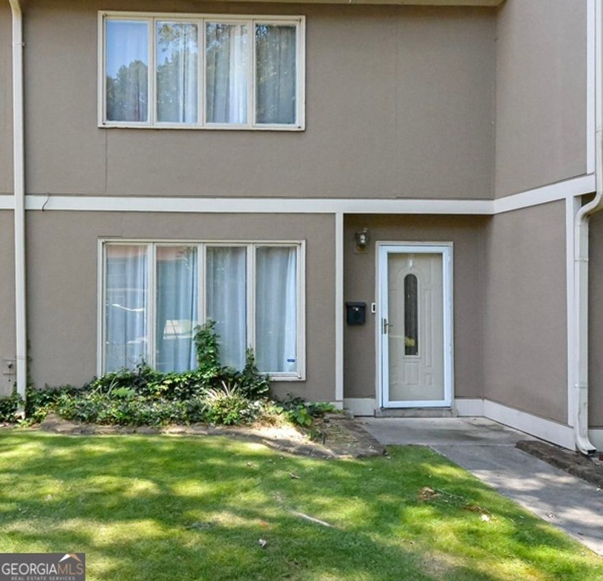 Charming updated condo located in a desirable swim and tennis community is a must see! This move-in-ready home is close to shopping, hospitals and entertainment. Highlights include a newly renovated kitchen with an induction stove, quartz countertops with a connecting island, eat-in area and abundant natural light. Spacious living room features an electric fireplace and modern built-in shelving, ideal for relaxation and entertaining. Enjoy outdoor living in the private fenced backyard, perfect for unwinding after a busy day. HOA covers lawn care, trash, water, sewer, termite treatment and insurance providing hassle-free living. Located just minutes from parks, Atlanta United FC, Braves Stadium, diverse dining options, Life University, Kennesaw State University, and Cumberland Mall. Don't miss this great opportunity to own this updated beauty at an affordable price.