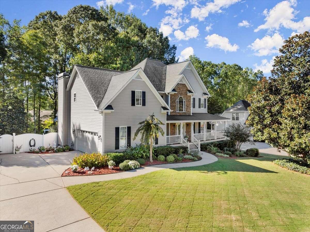 Majestically Upgraded Home with Partially Finished Basement and Heated Inground Saltwater Pool! Conveniently located in the quiet community of Oak Grove Estates just moments from East Paulding High School, this 4BR/2.5BA, 3,000+sqft property seamlessly combines luxurious updates with an ultra-homey vibe. Presenting like a cozy holiday postcard, the Southern charmer welcomes with a covered rocking chair front porch, mature landscaping, community street lights, and a sprawling 0.59-acre lot. Built in 1999, the upgraded home features a grand two-story foyer with 2 coat closets, hardwood floors, crown molding, spacious living room, powder room, and an elegant formal dining room with classic wainscoting. At the heart of the home, the gourmet kitchen, remodeled in 2020, showcases the quarter sawn white oak inlay custom cabinetry that extends to the ceiling with glass-front display doors, a spacious center island, a wine cooler, black stainless-steel appliances, and a gas range. High-end finishes, including a Brizo faucet, Blanco sink, and custom pull-outs for effortless organization, elevate the kitchens design. Watch your favorite movie in the fireside family room (vaulted ceilings) or hang out in the partially finished basement at the 200-yr old deep mahogany bar with a Kegerator and small refrigerator. Outdoor gatherings are always exciting in the fenced-in backyard, which has a heated saltwater swimming pool, built-in firepit, deck for grilling, and a screened-in porch. Relish in the many of comforts of the primary bedroom. Deep tray ceilings add a sense of grandeur, while the walk-in closet allows for maximum storage. Recently remodeled, the spa-inspired en suite mesmerizes with an oversized step-in shower, dual vanities, and a built-in makeup vanity. Other features: 2-car garage, boat door at rear of home, workshop, basement storage, laundry room, spacious guest bedrooms, office and irrigation system. Kitchen & family room hardwood floors installed in 2021. 4-Year-old kitchen appliances remain with home including the French door refrigerator. Near shopping, restaurants, and more! Have all the advantages of the good life, right here in Dallas.