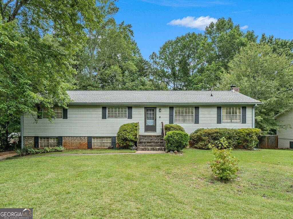 Spacious RANCH situated between Woodstock & Roswell with Cherokee taxes. Imagine the possibilities with this 4-bedroom, 2-bathroom space - the perfect canvas for your vision. This spacious four-bedroom, two-bathroom home spans 2,600 square feet. The low-maintenance exterior includes durable vinyl siding and a traditional brick foundation. Enjoy the spacious fenced backyard, which is perfect for adding a garden or fire pit. The main level offers a beautiful stone fireplace in the spacious living room. The versatile dining room can also be used as an office, and a spacious kitchen with direct access to a deck is ideal for outdoor dining. The oversized primary bedroom has an ensuite bath. Two secondary bedrooms share a tiled bath. The finished basement provides a secondary living space, including a bedroom, a flexible room for a game room or office, a laundry area, and ample storage. Located in the sought-after River Ridge High School district, this home invites you to envision its full potential. Sold as-is, this gem is waiting for your personal touch.