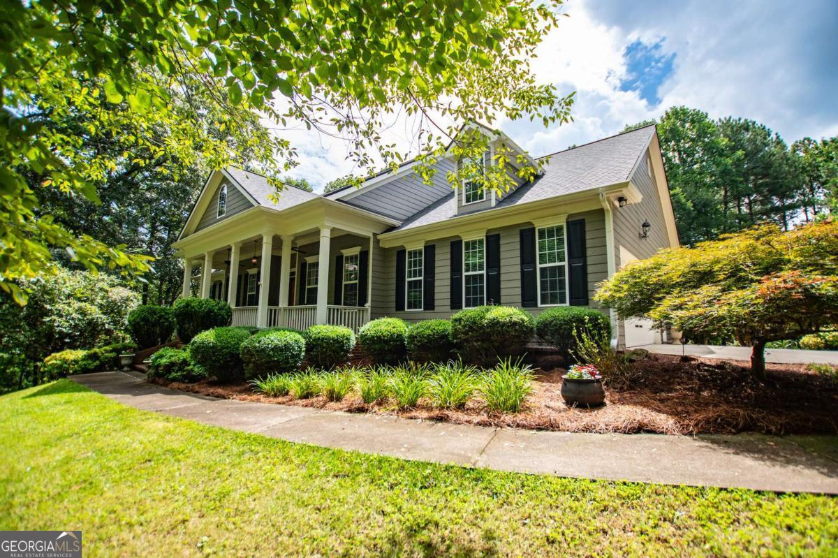 Welcome to your dream home-a beautifully designed Frank Betz ranch-style floor plan set on 3 serene and private acres. Tucked away down a long private driveway, this spacious 5-bedroom, 4-bathroom residence offers the perfect blend of comfort, luxury, and functionality. Main level highlights include gorgeous custom hardwood floors and soaring ceilings that create a grand yet inviting atmosphere. The Spacious family room includes a cozy gas fireplace, high ceilings, abundant natural light, and seamless flow to the formal dining room. Chef's kitchen is spacious and well-appointed with a large center island, eat-in breakfast area, and tons of counter and cabinet space-perfect for entertaining. The spacious owner's suite on the main floor encourages you to relax while enjoying a private retreat featuring double vanities, a spa tub, a separate shower, and a walk-in closet. Three Additional Bedrooms and two full baths offer space for family or guests. A walk-in laundry room with a sink on the main floor makes convenience a breeze! The finished basement is a show stopper with a complete family room with custom bar area, game room, home office, an additional guest room, full bath, and tons of storage, including a workshop and room for landscaping equipment! The outdoor living and features include a relaxing covered front porch, a large back deck for relaxing or entertaining, and a slab below ideal for gatherings or quiet relaxation! The spacious private backyard is fenced for pets, play, or gardening! Enjoy the sound of the bubbling creek along the backside of the property! Additional parking includes an attached 2-car garage and a detached custom-built covered carport perfect for additional vehicles or equipment! Don't miss this rare opportunity to own a private retreat that feels like a getaway-but with all the comforts of home.