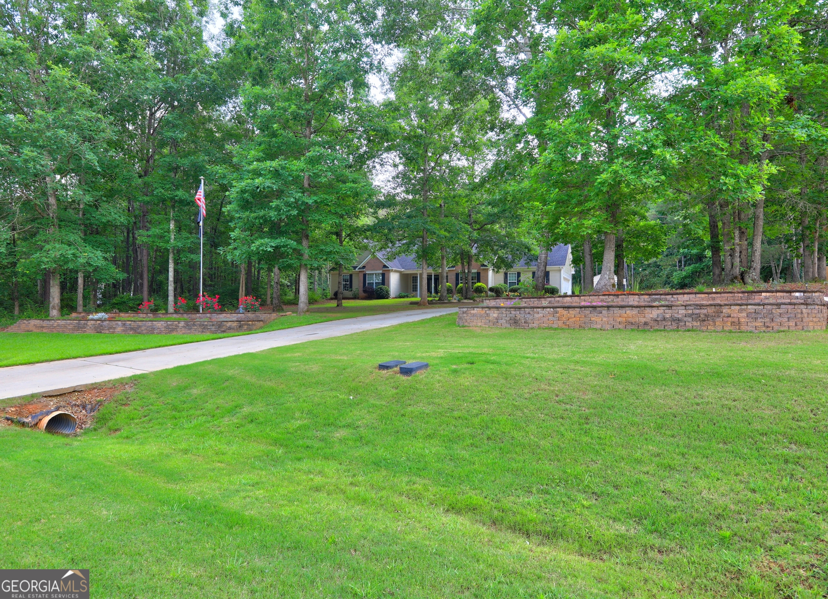 196 Liberty Trace in Milner, GA is waiting on you!!! This charming property offers a Extra large outbuilding, ideal for lawn equipment or a workshop for all your DIY needs; as you step into the backyard you'll find a serene, fenced-in space complete with a covered, screened-in patio, perfect for relaxing or entertaining. The front yard is equally impressive, showcasing a beautiful flagpole that adds a touch of patriotism framed by the meticulously crafted stone retaining walls. Additionally, an invisible fence by Dog Watch ensures your furry friends can roam freely and safely, making this home a perfect haven for pet lovers. Surrounded by natural beauty, this 3 bedroom 2 bath home offers a perfect blend of comfort and modern living, greeting you with warm interiors that reflect a thoughtful design, and a well equipped, recently remodeled kitchen with modern appliances and quartz countertops. Conveniently located, Just 9 mins from I-75 access, 10 mins from Historic Downtown Barnesville, Gordon State College and 12 mins from High Falls State Park. Call to schedule your personal tour *Existing home warranty to be transferred upon closing