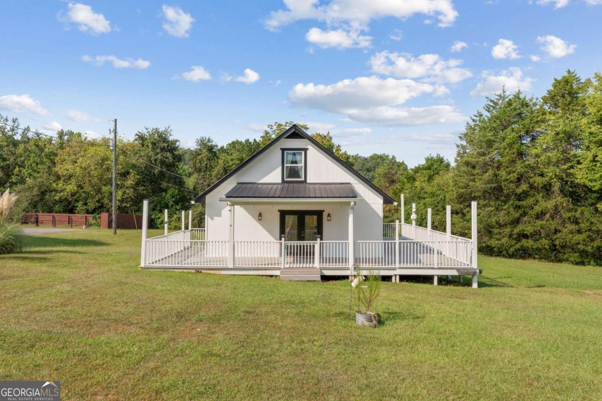 Welcome home to this charming 3-bedroom, 1.5-bath property nestled on a peaceful 3/4 acre lot in Cedartown, GA. Perfect as a starter home or investment opportunity, this residence combines modern updates with classic appeal. Step inside to find new carpet upstairs, fresh vinyl windows that bring in natural light, and durable new cement siding for lasting curb appeal. The metal roof offers peace of mind, while the low-maintenance composite deck is the ideal spot to relax or entertain during cool Georgia evenings. Cedartown is known for its small-town warmth and convenient location. Just minutes away, you'll find downtown Cedartown's historic charm, local dining, and shopping. Outdoor enthusiasts will love being near the Silver Comet Trail, perfect for biking, jogging, or a leisurely stroll, and within easy reach of Lake Weiss for fishing and boating getaways. With quick access to Rome and the Alabama state line, this home offers both comfort and convenience. Don't miss your chance to own this quaint Cedartown gem with updates already in place-ready for you to move in or add to your portfolio.