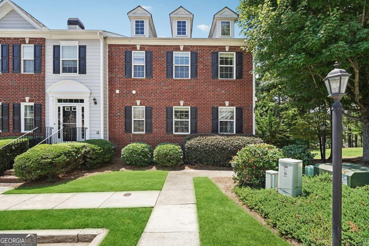 Discover your dream retreat in this rare corner-end townhome in the heart of Sugar Hill! Step inside to find rich hardwood flooring across the main level, paired with a bright neutral palette that radiates warmth and style. The chef's kitchen is a showstopper, boasting sleek stainless appliances, rich stained cabinets, and a built-in microwave-perfect for whipping up your favorite meals or hosting lively gatherings. The expansive open floor plan effortlessly connects the kitchen to the living area, creating an inviting space ideal for entertaining or cozy nights at home. Upstairs you'll find the stunning owner's suite, where elegant trey ceilings set the tone for comfort, complemented by a spa-like ensuite featuring a soaking tub, double vanities, and a large shower that promises pure relaxation. Two spacious secondary bedrooms offer ample room for family, guests, or a home office, while a beautiful loft with bay windows provides a charming hideaway for movie nights or quiet reading. Step outside to a large back deck, your personal oasis for morning coffee or evening soirees. Perfectly located with quick access to I-20, you're just moments from vibrant local shopping, dining, and scenic parks (Gary Pickle Park), Dogs parks (Settle Bridge Park and Ridge Lake Park). Lake Lanier (3 miles), supermarkets (Kroger, Publix next to the neighborhood) all while zoned for top-rated schools. Schedule your showing today and embrace the Sugar Hill lifestyle you've been looking for! Additional features: Garage door with Wireless system (can be open with MyQ app) Ring Door Camera allows to view who is outside and will ring on the phone as well (paid subscription allows to record videos and set areas for the notifications) Security system on the main doors. Smart Thermostats allows to use the Google nest app to control the AC units and join electricity provider discounts. All lights were changed for LED to reduce electricity bill. Extra private space for the parking next to the house. Tennis court resurfaced a month ago.