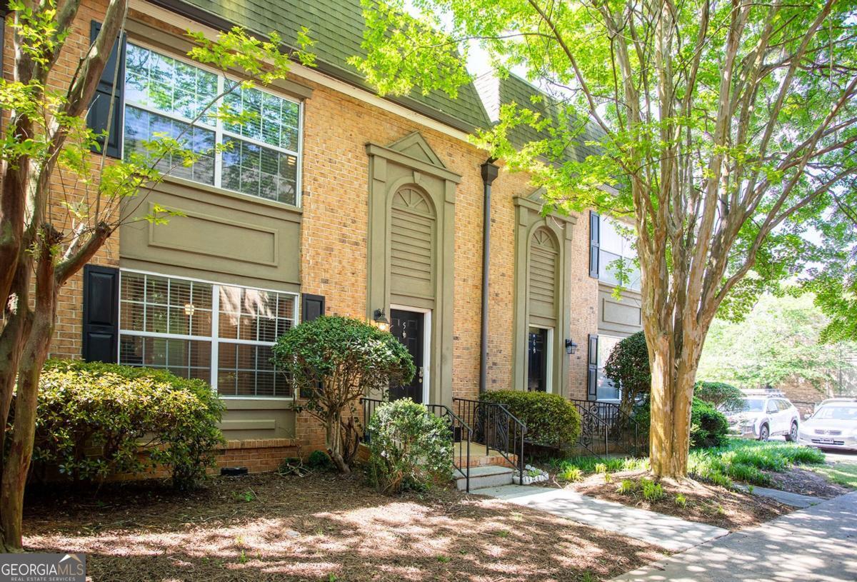 Option to Lease-to-Purchase Available - A Perfect Path to Homeownership! Discover this completely revamped townhome located in a gated community in the heart of Sandy Springs. Step inside to find wide-plank hardwood floors, a custom built-in bookcase in the foyer, and an open dining room perfect for entertaining. The oversized eat-in kitchen features white cabinetry, granite countertops, stainless steel appliances, a subway tile backsplash, double ovens, and a walk-in pantry with pull-out drawers. The spacious living room offers crown molding, recessed lighting, and French doors that lead to a private balcony - perfect for relaxing or entertaining guests. Upstairs, retreat to the jumbo primary suite, complete with two custom closets (including a specialized accessories closet) and a large walk-in with smart built-ins. The en-suite bath includes a double vanity and jetted soaking tub. This home is situated in Sandy Springs' most desirable location, close to restaurants, shopping, parks, and major roadways.