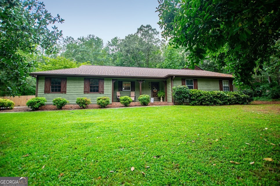 YOU will BE AMAZED! This CHARMING ONE-LEVEL 3 bed, 2 bath home is exactly what you've been WAITING for with NO HOA! GORGEOUS WOOD FLOORS and majestic fireplace greet you as you enter the foyer, expansive GRANITE counters in the kitchen with subway tile, stainless steel appliances with a welcoming dining space overlooking the backyard and patio for all your entertaining desires! Huge owners suite with a walk-in closet is perfect for you to relax and wind down. Enjoy your backyard with lots of privacy, with a fire pit and a storage outbuilding for your workshop or hobbies, in addition to storing all your outdoor tools. The 2-car garage, along with a nice-sized utility room, makes this home complete. **BONUS** OPTIONAL pool association! This is the only neighborhood in West GA with an optional pool and green space for you and your guests during the summer months! Schedule your showing today!
