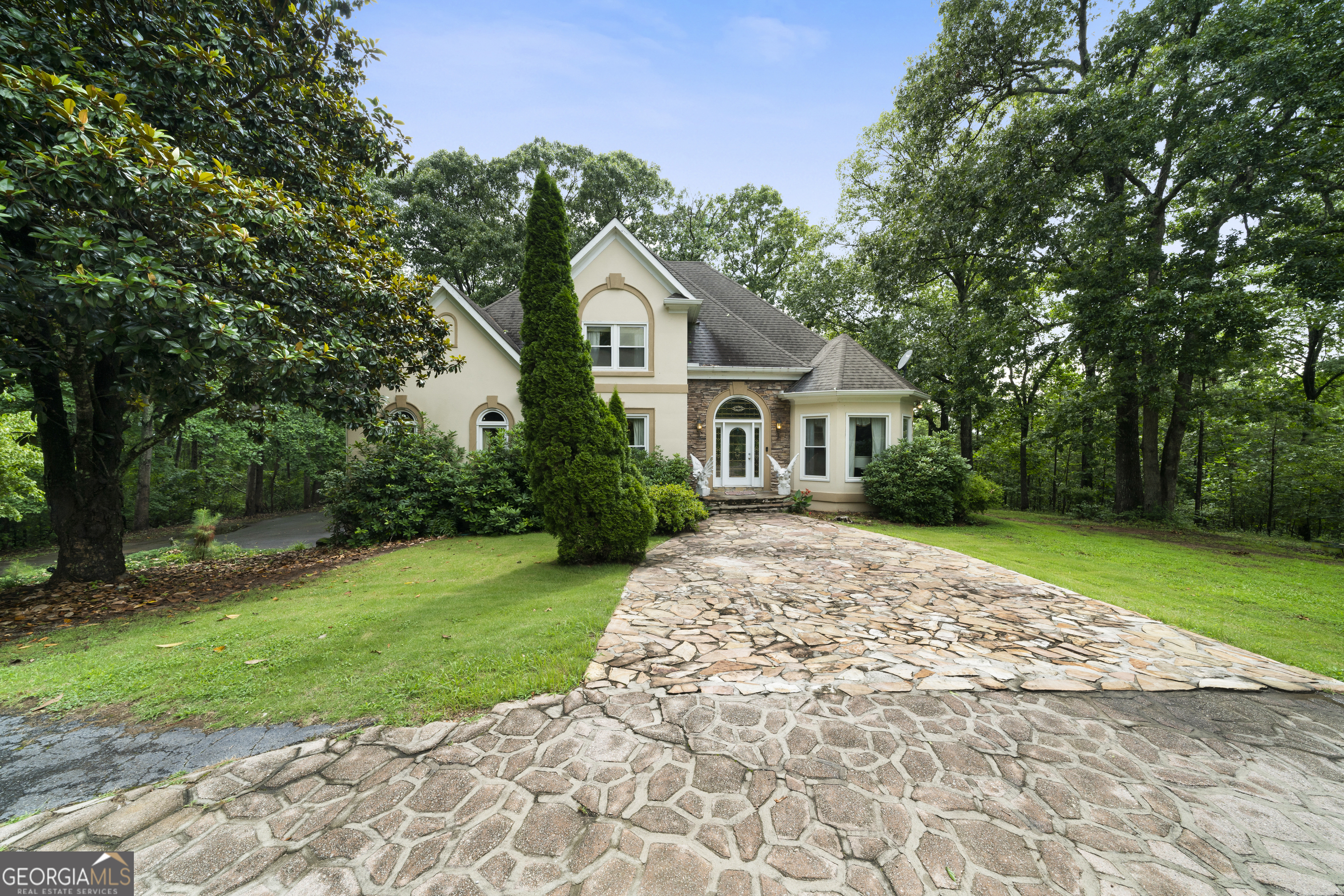 Unique find on 10+ acres in South Paulding! Step into this authentic styled home featuring 4 bedrooms, 3.5 baths on a private lot. Entrance foyer with gorgeous staircase leading upstairs. Library with built in bookshelves, large open great room with fireplace. Enormous kitchen with island, double ovens, breakfast area and bar. Dining room for entertaining all of your guest. Over sized private owner's suite with bath, soaking tub, shower, and double vanities. Additional bedroom on main with private bath. Half bath for guest on the main. Travel upstairs via a second staircase with two additional bedrooms, a bonus room, full bath, and office. Laundry room on main. In ground pool with pool house/bath for enjoyment and entertaining. A rare find in an excellent location.