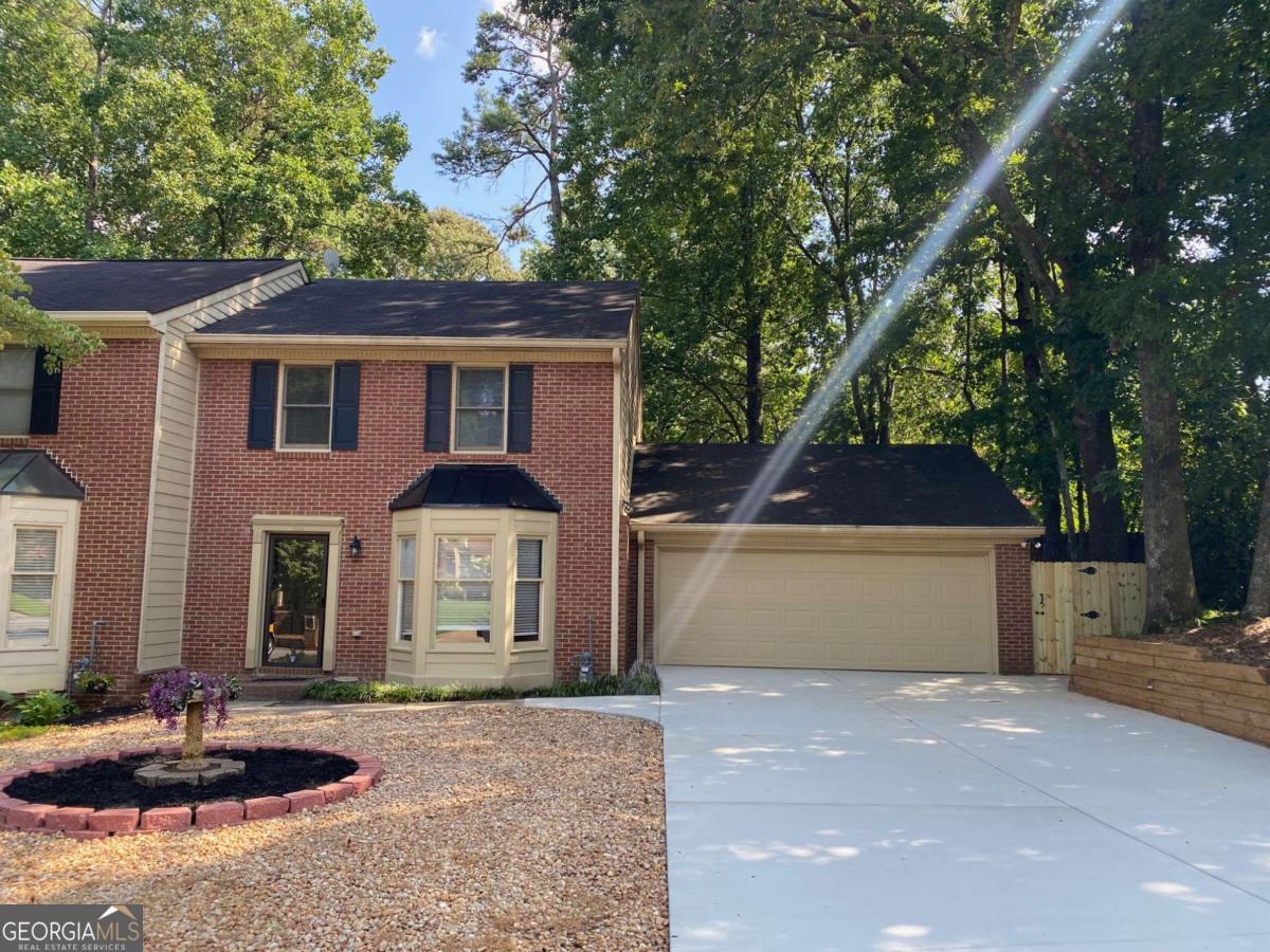 This 2 bedroom 2.5 Bathroom wooded, corner lot townhome is ready for a new tenant! Both 2nd story bedrooms are "suites" as each has an attached full bath. The laundry is conveniently located upstairs, and the main suite has a whirlpool tub. This home is newly renovated with all new carpet upstairs and Luxury Vinyl Planks downstairs; all new interior paint, and a new granite countertop in the eat-in kitchen. There is a large under-stair storage area on the main floor. A gas fireplace is the highlight of the open concept living room and pass through kitchen area. The detached 2 car garage boasts a workbench and cabinets, and opens out to a newly poured patio and fully fenced backyard. This home is within walking distance to Marietta Highschool, grocery shopping and restaurants. It is located off of Dallas Highway, within a 5 minute drive to Historic Marietta Square and Marietta Market with endless local theater, seasonal outdoor entertainment, bars, restaurants, and specialty shops. Fabulous location, unique lot, and newly renovated - a must see! Availability September 26th.
