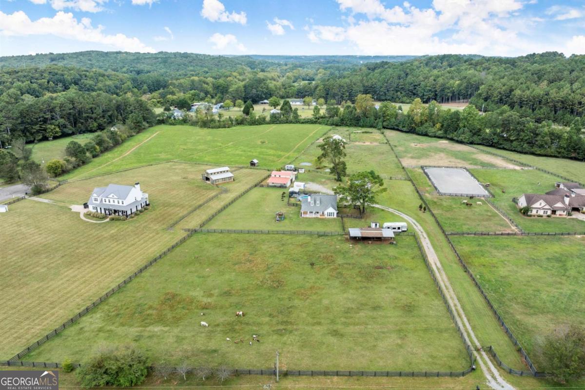 Set on 5.7 acres, this fully fenced estate is a dream for equestrians or those seeking a bit of space and freedom. The custom-built modern farmhouse features a chef's kitchen with granite countertops, stainless steel farm sink, and bar nook. The interior has been freshly painted in soft neutral tones, creating a bright and inviting atmosphere. The main-level primary suite offers a spa-like ensuite with a newly renovated shower and a walk-in closet. Upstairs, two additional bedrooms share a full bath. A charming guest cottage with a loft bedroom, and full bath provides additional living space, a great space to have guests stay or make it your work-from-home office retreat! The main barn includes a renovated loft apartment, a separate laundry room, and a 3 car garage, currently used as storage. A separate, pinterest perfect, white 2-stall barn, arena, run-in shelter, and chicken coop complete the farm amenities. There's also plenty of room for RV parking! The outdoor space is perfect for both relaxation and entertaining, with a pool area surrounded by Trex decking and a cabana, all overlooking the pastures. No HOA and located on a quiet, upscale street, this property offers both privacy and luxury. Schedule a tour of Painted Sky Farm today!