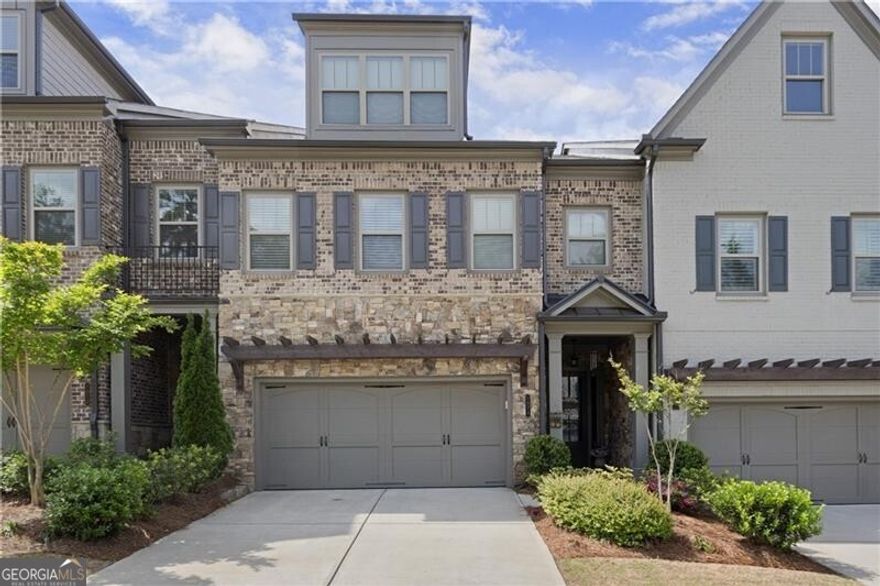 Welcome to easy, low-maintenance living in the heart of Harlow East - one of Alpharetta's most vibrant gated communities. This beautifully maintained three-story Concord Plan townhome offers the feel and space of a single-family home, with thoughtful upgrades throughout. Wide-plank hardwood floors flow across the open main level, where a gas fireplace, sun-filled living spaces, and a chef's kitchen with stainless appliances, a built-in microwave, a walk-in pantry, and a butler's pantry come together beautifully. Step outside to a fenced backyard, perfect for unwinding after a busy day or letting your pup out with ease. One of the best features? A pre-installed elevator shaft gives you the option to easily add an elevator - allowing true main-level living without ever worrying about stairs. Park in the spacious two-car garage, bring groceries right inside, and enjoy the convenience of everyday life made simple. Upstairs, the oversized primary suite offers a private sitting area, a spa-like bathroom with a freestanding soaking tub, oversized walk-in shower, double vanities, and a custom walk-in closet that connects directly to the laundry room with built-ins and a utility sink. Two additional bedrooms and a full bath complete the second floor. The top level features a massive open loft with a sleek wet bar, a fourth bedroom, and another full bathroom - perfect for guests, an office, or multi-generational living. Life at Harlow East is more than just a beautiful home - it's a lifestyle. Residents enjoy resort-style amenities including two swimming pools, tennis and pickleball courts, green spaces, scenic walking trails, two dog parks, a fire pit, and even a community vegetable garden. The spacious clubhouse features multiple gathering areas, a full kitchen, coffee bar, and large-screen TV, and is home to a packed calendar of events - from ladies' nights and poker nights to food trucks, wine tastings, golf outings, and live music on the green. Walk to concerts at Ameris Bank Amphitheatre in under five minutes, and enjoy being minutes from Downtown Alpharetta, Avalon, Historic Roswell, Big Creek Greenway, and easy access to GA 400. Zoned for top-rated Manning Oaks Elementary, Northwestern Middle, and Milton High School, this home offers not just style and comfort - but true community. Experience the best of Alpharetta living - where every detail is designed to make life easier, more connected, and a whole lot more fun. Schedule your private showing today!