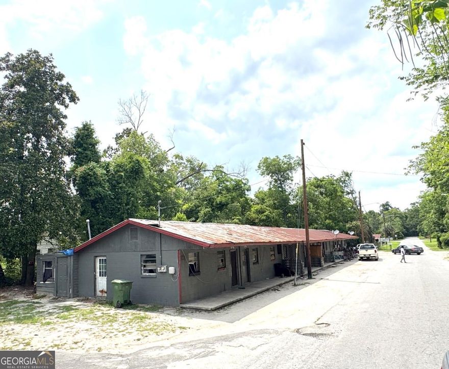 Unlock the potential of this unique investment package! This offering includes a seven-unit apartment building, a vacant buildable lot, and an additional lot with dilapidated house.  The apartment building is a block structure with a metal roof, housing seven individual 1-bedroom, 1-bathroom units, each equipped with a kitchen and window AC units. No laundry.  Water/Sewer included in rent.  Tenants pay for Electricity with Ga Power.  While all units require renovation, five are currently tenant-occupied, generating a steady income of $300 per unit. This provides an immediate revenue stream while you plan and execute upgrades to maximize rental income.  Adding to the value is a 0.17-acre vacant lot directly across the street, offering prime potential for new construction, additional parking, or future development. Furthermore, a 0.37-acre lot located behind the apartment building at 379 N Cypress Street, which currently hosts a dilapidated house, is also part of this package.   This is a comprehensive package deal perfect for investors looking to acquire a multi-faceted property with diverse income-generating and development possibilities.  Property is priced according to condition and being sold As Is.