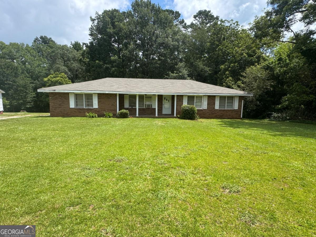 Bring your vision to this delightful 3 bedroom, 1.5 bathroom brink ranch. Brimming with character the home features gorgeous original hardwood floors, flowing through the den and bedrooms, plus beautiful retro tile that adds vintage charm to the bathrooms. Enjoy gatherings in the spacious dining room, perfect for hosting family and friends. Sitting on a generous .45 acre lot there's plenty of outdoor space to create your ideal yard or garden retreat. This home needs a little TLC, making it a fantastic opportunity to restore and personalize a classic property to your taste. Don't miss the chance to make this gem shine again!