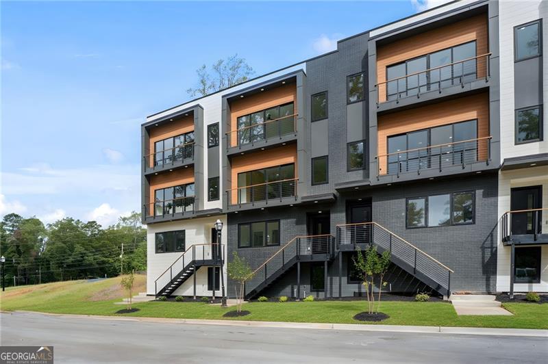 Claim the executive lifestyle you've earned at Grand Terraza-Decatur's premier new address for luxury townhome living. Designed for the professional who demands excellence without compromise, these stunning new-construction townhomes offer an expansive 2,470+ sq. ft. across four thoughtfully designed levels. Whether you're hosting colleagues or simply unwinding after a demanding week, you'll appreciate the 4 bedrooms, each with its own private en-suite bath, ensuring supreme comfort for family and guests. The owner's suite serves as your private retreat, featuring custom built-in shelving and spa-inspired finishes that redefine luxury. Inside, every detail speaks to a curated, high-end aesthetic: Luxury Premium Contemporary SPC flooring offers the rich look of hardwood with unmatched durability, complemented by quartz countertops, designer lighting, custom cabinetry, and premium appliances. Rare two-car garages plus driveway parking eliminate the urban parking headache, while private outdoor terraces and select finished basements provide ideal spaces for sophisticated entertaining or quiet contemplation. Your time is valuable. Grand Terraza delivers an unparalleled location that makes your commute effortless: just 4 miles to Emory, 5 miles to the CDC, and 7 miles to Downtown Atlanta. With a nearby MARTA station, city access is seamless, allowing you to reclaim your evenings. This vibrant Decatur neighborhood puts you minutes from boutique restaurants, charming coffee shops, and cultural hot spots-all the amenities a cosmopolitan lifestyle requires. Smart energy efficient construction and a builder's warranty offer confidence in every detail. This isn't just a home; it's a strategic investment in your quality of life. Luxury. Convenience. Prestige. Secure your future at Grand Terraza, where modern sophistication meets effortless in-town living.