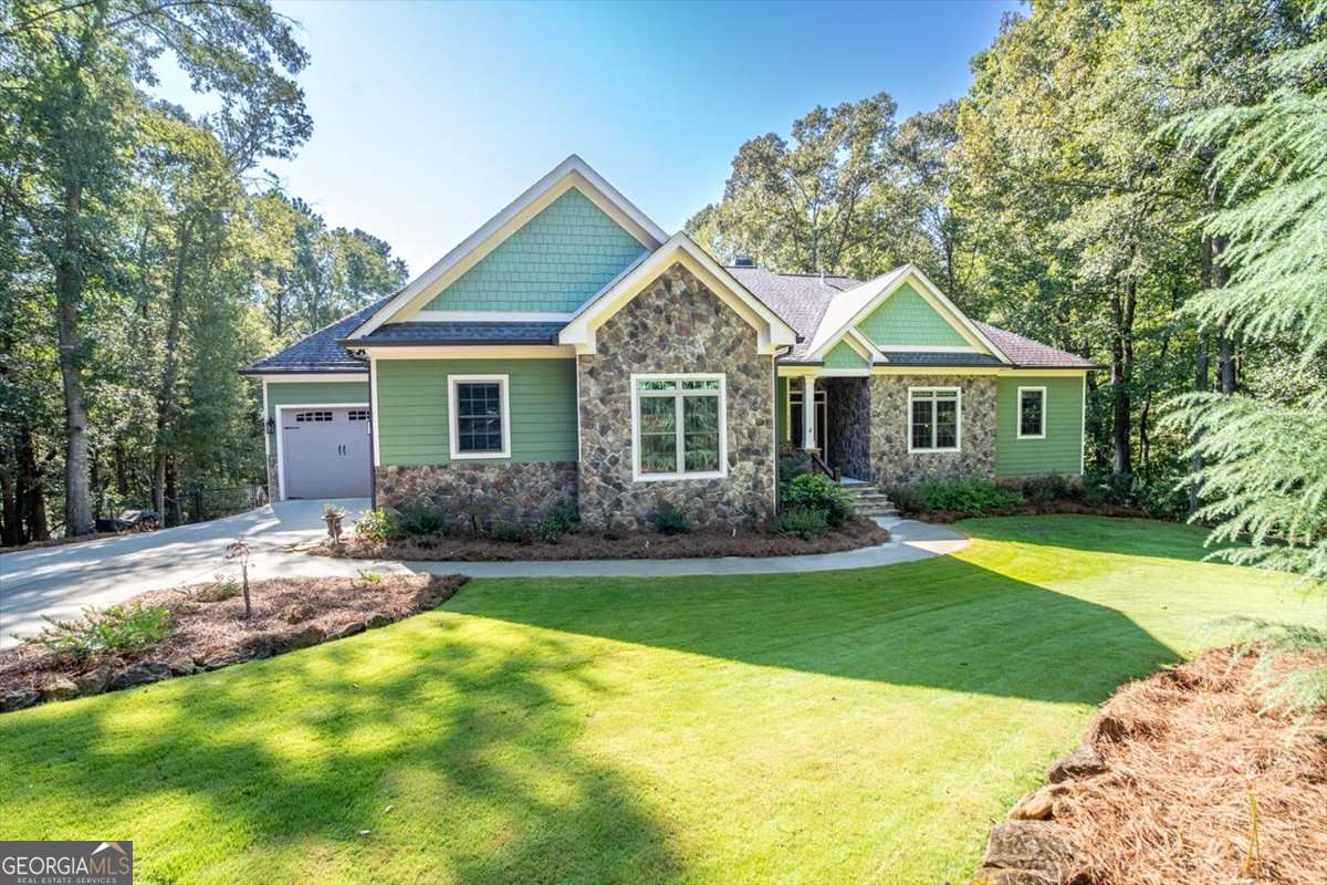 Modern Craftsman Home on 7.7 acres in Watkinsville and minutes to Five-Points and UGA! Adjacent Newly Remodeled Scenic Estate on 5.79 Acres with Pool & Guest House is also for sale and can be combined to create a private compound. Built in 2017, this 3-bedroom, 3.5-bathroom home offers 2,600 sq. ft. of thoughtfully designed living space on the main level, plus a 2,600-sf unfinished basement with a finished full bath. The space is perfect for future expansion and guest accommodations. Step inside to find an open-concept layout with high 10' ceilings, abundant natural light, and quality finishes throughout. The spacious kitchen features quartz countertops/stainless steel appliances/custom cabinetry, and the largest hidden pantry you have seen! The kitchen flows seamlessly into the dining and living room that overlook the picturesque fenced in backyard and pond area. The living room has cathedral ceilings with beams and a floor to ceiling wood burning rock fireplace. Off the living room is a private office space. The primary suite is a true retreat with a spa-like bathroom and generous walk-in closet. Two additional bedrooms with a full bathroom, for family or guests. The laundry room is conveniently located off the primary suite. Downstairs, the basement offers endless potential. The bathroom has already been completed with the remaining space ready to be turned into a media room, gym, and additional living quarters. There is space for it all! Outside, enjoy the large fenced in backyard, screened in covered porch, with wooded lot privacy. The property offers both space and tranquility, all while being just minutes from downtown Watkinsville, award-winning Oconee County schools, and an easy drive to Athens. A rare opportunity to own a newer home in this prime location. Schedule your showing today!