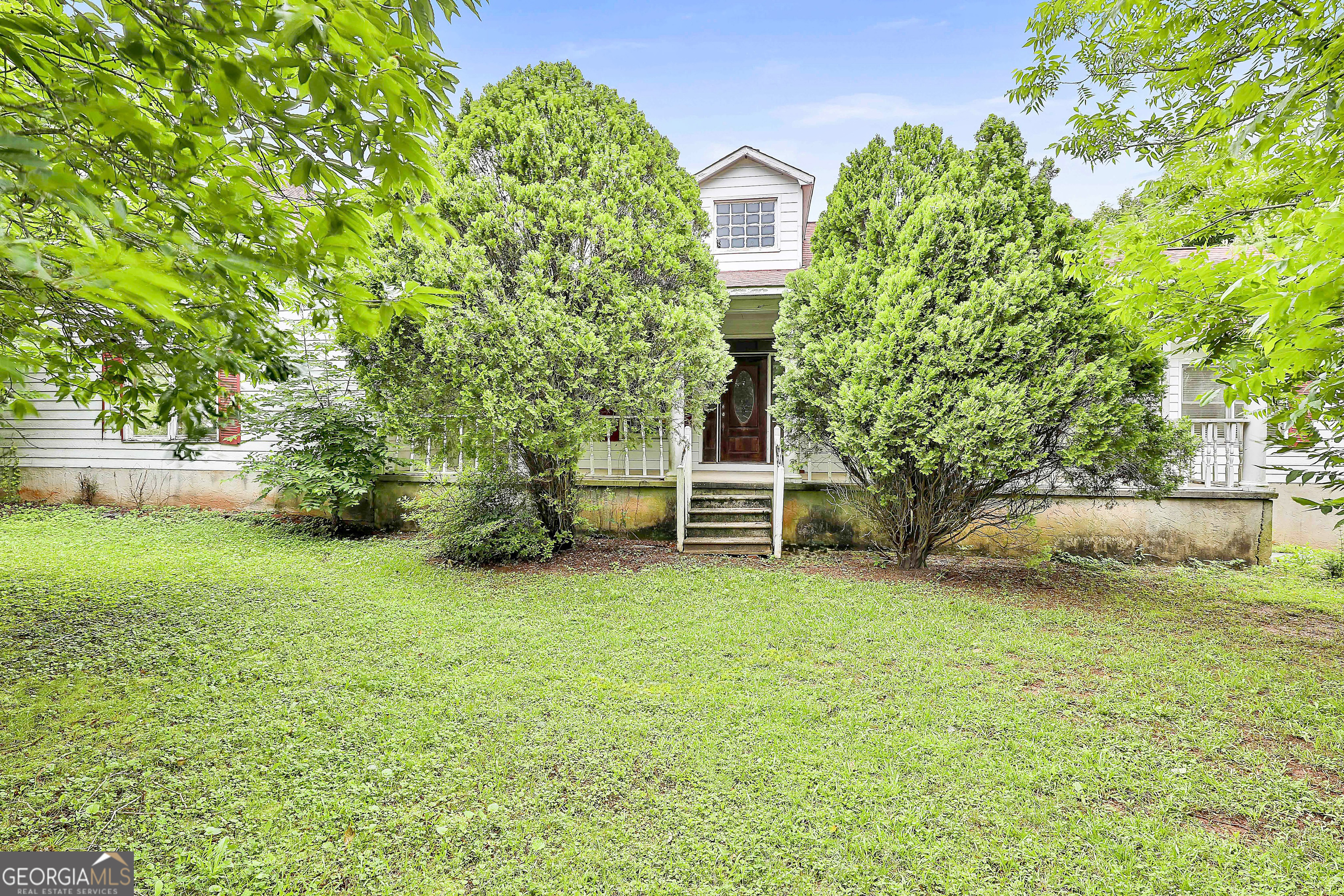 Welcome to a hidden gem with endless potential! This spacious 3-bedroom, 2-bath ranch sits on over 6.6 acres of rolling hills, offering privacy, charm, and room to grow. With over 2,200 square feet on the main level plus a full unfinished basement, this home provides a solid foundation for your vision. Step inside to find hardwood floors, solid wood doors, crown molding, and a cozy living room with a wood stove fireplace-just waiting for the right updates to make it shine again. The layout includes a screened porch off the kitchen and a covered front porch perfect for morning coffee or relaxing evenings. Per a previous MLS listing, the property may feature a variety of mature fruit and nut trees, including chestnuts, walnuts, nectarines, pears, plums, apples, and even Li/Lang jujube and persimmons. While we haven't confirmed every variety, there's no denying the natural beauty and unique setting this land offers. This is your chance to bring new life to a home with good bones and a peaceful setting. Schedule your tour and explore the possibilities today!