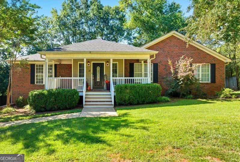 Well, hello! You're invited to come visit 11 Chestnut Street! This charming brick beauty offers great space and convenient location. It is nestled close to the heart of downtown Cartersville and just a short drive to both Hwy 41 & I-75. On a quiet corner lot, you'll find mature landscaping, privacy fencing and a spacious driveway. 11 Chestnut Street is 4 bed/2.5 bath in the City of Cartersville school district with a living room so spacious you can bring (or buy!) that sectional! You'll find an open dining area right off the kitchen with its stainless steel appliances. Off the kitchen is a lovely remodeled deck with a nice view and great spot to grill out! Further inside you'll see three welcoming bedrooms (all with generous closet space!) along with a half bath and full bath between them, as well as the laundry area. The master bedroom offers both space and privacy, has a walk-in closet and en-suite bath which hosts a double vanity, garden tub, and separate shower. This home has over 2100 sq. ft of living space sitting over a full basement with 2 garage bays and rooms ready to be finished out for your home office, media room, teen room, or additional suite - make it your own! With both comfort & convenience you will truly feel at home on Chestnut Street. Schedule your showing today!