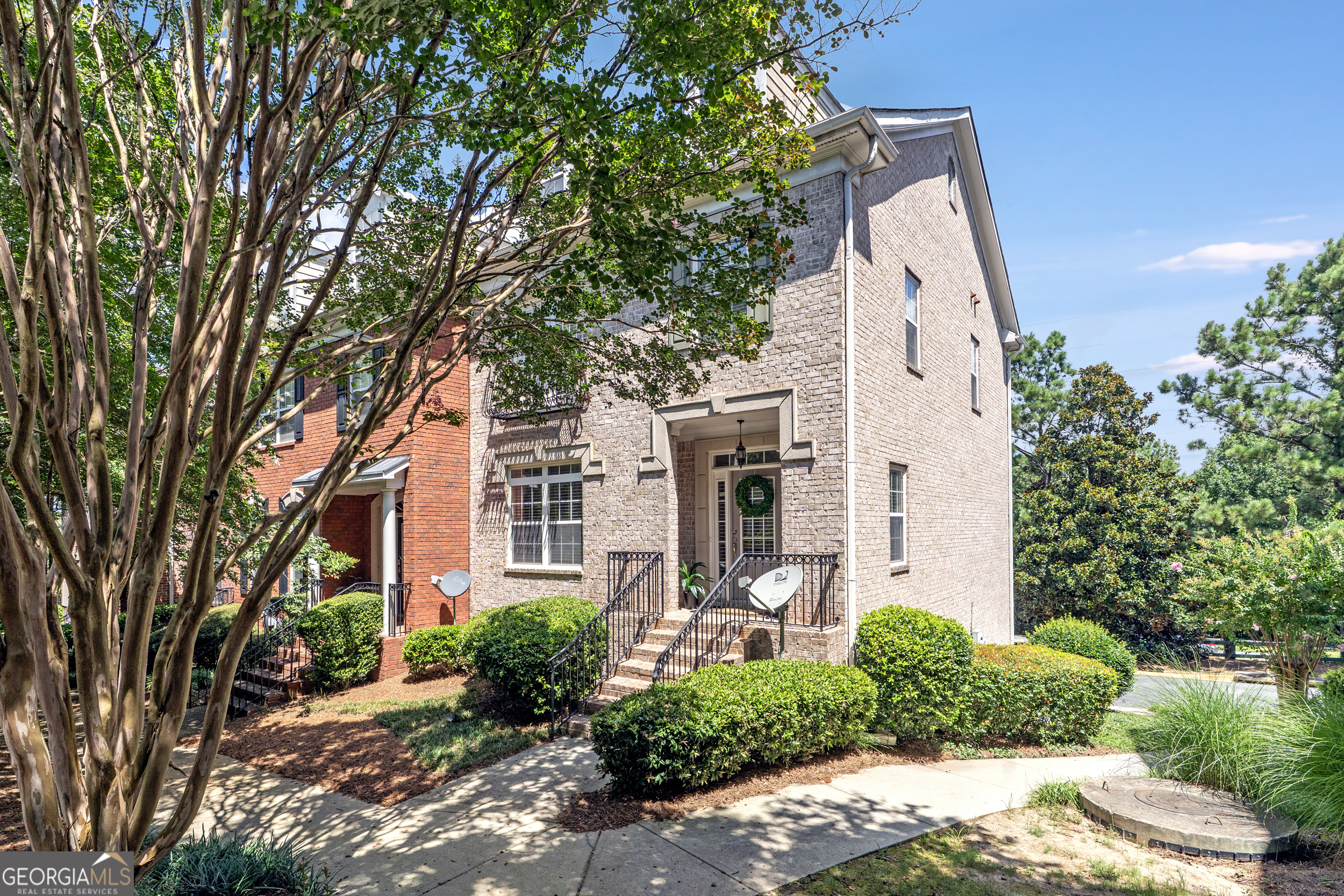Charming 3-Bedroom End Unit Townhome + Finished Basement Bonus Room in Gated Community- Step into comfort and timeless style in this beautifully maintained end unit townhome, offering 3 bedrooms, 2 full baths, and 2 half baths, including a flexible finished basement. Located in a secure, amenity-rich gated community, this home combines privacy, convenience, and thoughtful design. Natural light fills the main level, where an open kitchen flows effortlessly into the family room-ideal for both everyday meals and entertaining. A butler's pantry adds functionality and elegance, while a cozy fireplace creates a perfect focal point in the spacious living room. Just off the main living area, a generous deck invites you to unwind outdoors. Upstairs features three comfortable bedrooms, including a relaxing primary suite, and two full bathrooms. A half bath on the main floor adds everyday ease, while the basement offers a bonus room with its own half bath -perfect for a home office, gym, or media lounge. Set at the end of the row, this townhome enjoys added privacy and a peaceful atmosphere. The view from the front door is truly picturesque, setting the tone for the charm within. You're just minutes from great schools, everyday shopping, dining, and major commuter routes. Plus, you're close to all the excitement of Truist Park and The Battery. If you're seeking a low-maintenance lifestyle in a prime location with space to grow and entertain, this is the one.