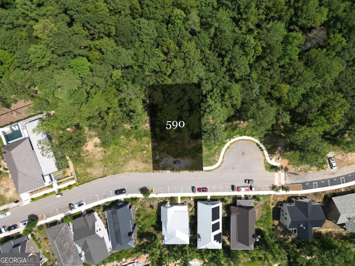 Perched along the Lupo Loop ridge line, this 0.21-acre estate lot offers the perfect setting to build your dream home, complete with panoramic treetop and sweeping sunset views. A prepared architectural plan featuring a terrace-level garage is already in place, allowing you to move forward with ease. Just a short distance from shops, dining, and health + wellness amenities, this homesite also provides direct access to over 20 miles of soft-surfaced nature trails, bringing the beauty of the outdoors right to your back door.