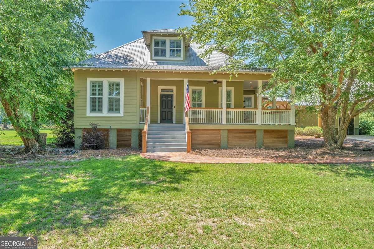 LAKE LOT W/ BOATHOUSE ACROSS THE STREET now included with this fantastic home with pool and pond! This home has the best of all worlds. This beautiful home located in N Valhalla sits on a huge 2.65-acre lot in front of a stocked 12-acre pond with a fantastic pool and Lake Blackshear access lot with double boathouse right across the street. This custom built 3-bedroom 3 full bath home has upscale appliances, very high-end marble countertops, wet bar, large, covered porches that look out over the pool and stocked pond with large master suite downstairs. Upstairs there are two large bedrooms with a huge walk-in-floored attic space for storage or future heated space. Setting is absolutely beautiful! This very unique property is shown by appointment only!
