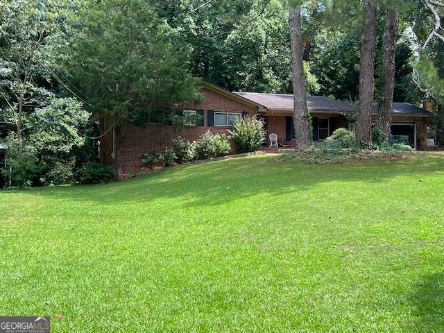 This split level (Ranch Style ) 4 bedroom has a huge kitchen with plenty of cabinets, island, located directly in view of the family room. The brick fireplace would ideal as a central gathering place after a family meal. The home boasts a formal dining room, living room, a converted ensuite bedroom of the back elevated deck. The lower living room has been converted into a two bedroom living space ideal for a short-term rental area. Please note the oversized lot with room to develop, or expand. With minor repairs, and alterations this home could be a showplace.