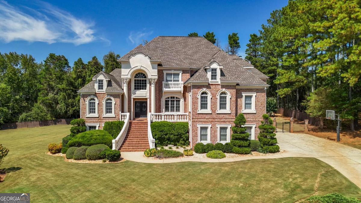 Resort Living at Its Best! This custom-built European-inspired home offers an unparalleled lifestyle, featuring a full-size indoor screened pool and spa with a cascading waterfall. Nestled on nearly an acre of lakefront property, this home perfectly blends elegance and comfort in a truly unique setting. Inside, you'll find two spacious master suites, a breathtaking two-story great room with a hand-carved fireplace mantle, and generously sized bedrooms, each with walk-in closets. The large chef's kitchen with breakfast area flows into a formal dining room, ideal for both everyday living and entertaining. The expansive finished terrace level offers a full kitchen, fitness center, bar, and family room-all with direct access to the indoor pool and spa for year-round enjoyment. Step outside to the beautifully landscaped backyard and unwind on the deck overlooking the tranquil lake. Additional highlights include a 3-car garage, excellent community amenities, and a prime location near Marietta Country Club, Mt. Paran Christian School, Kennesaw Mountain, and the vibrant Marietta Square. This is a rare opportunity to own a one-of-a-kind luxury home that combines exceptional design, resort-style living, and an unbeatable location!