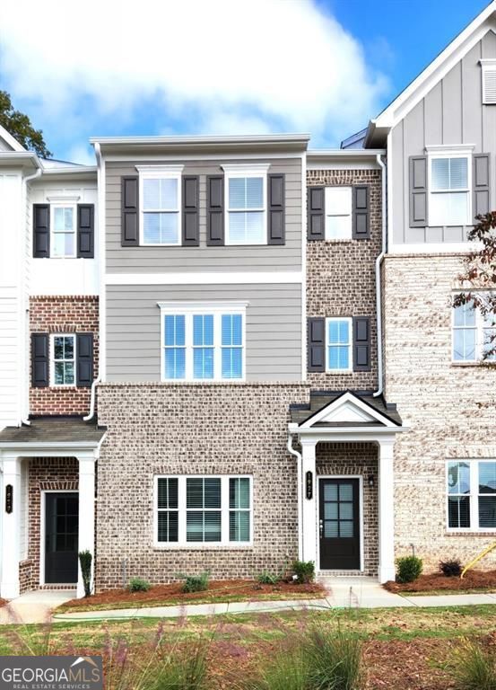 This brand - new townhome features a rear-entry garage with a bedroom/office and full bath on the ground floor. The main level offers an open concept with a spacious kitchen, gas cooking, a large island, dining room and half bath. The family room leads to a rear covered deck, ideal for entertaining. Upstairs, the primary suite includes a double vanity, shower, and walk in closet. While the secondary bedroom has a private bath. A convenient laundry room is also on this floor. East Park Village amenities include a pool, cabana, fireplace, and dog park. Located within walking distance of shops, restaurants and less than 3 miles to KSU. This beautiful townhome is available now!