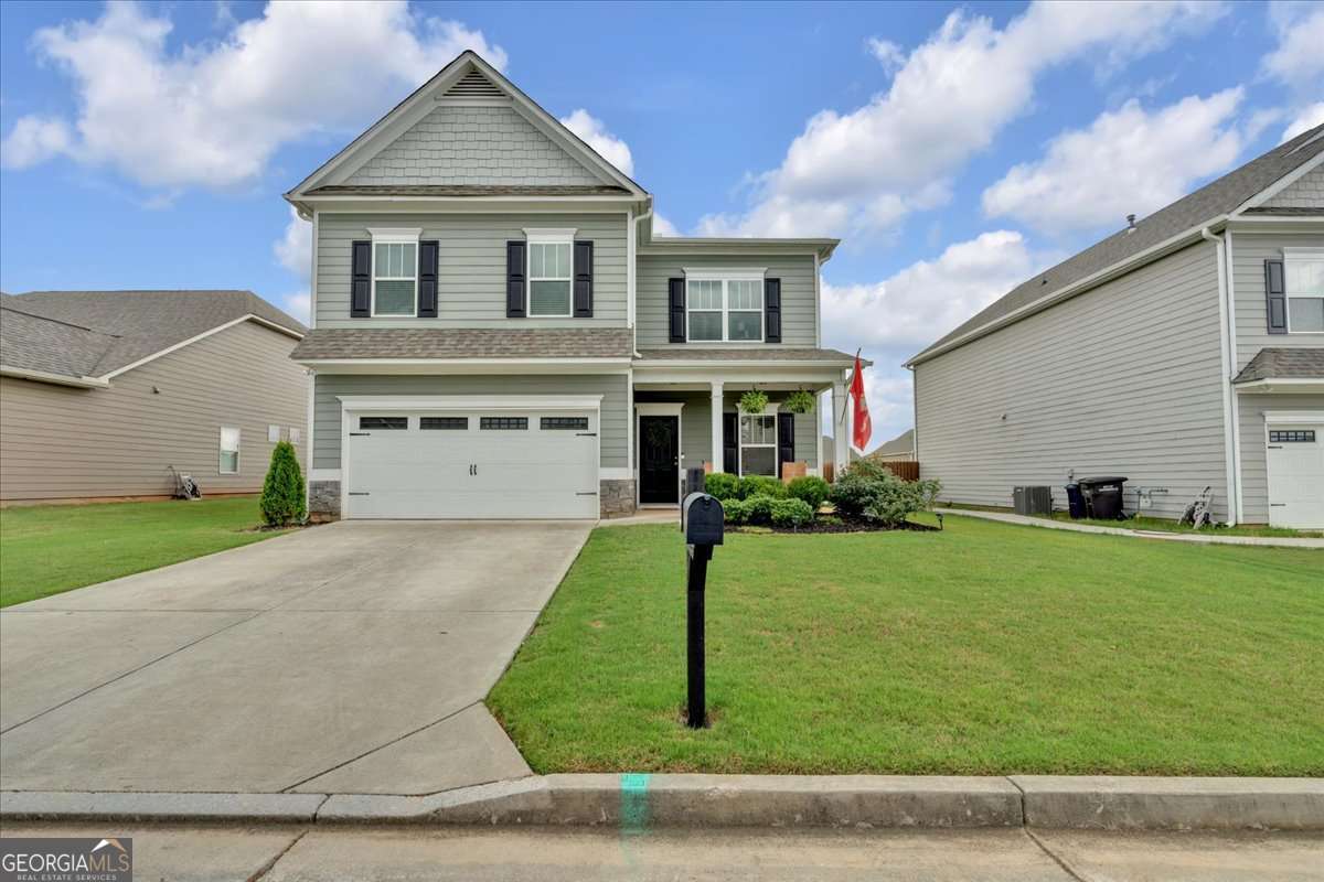 Welcome to this inviting 4-bedroom, 3-bath home in Cartersville, just minutes from shopping, dining, and schools. A welcoming front porch sets the tone for this charming property, while inside you'll find an open main living area with newly installed wide plank luxury vinyl flooring, built-in shelving, and a cozy fireplace. The kitchen is designed for both function and style, featuring an oversized island, stainless steel appliances, and ample cabinet space. Upstairs, the oversized primary suite includes a tray ceiling, private en-suite bath, and a large walk-in closet. Three additional bedrooms provide plenty of space for family, guests, or a home office. Outdoors, enjoy a fenced-in backyard, perfect for pets or gatherings, along with a storage building for added convenience. Combining comfort, space, and location in the desirable Cartersville City School District, this home is move-in ready and waiting for its next owner.