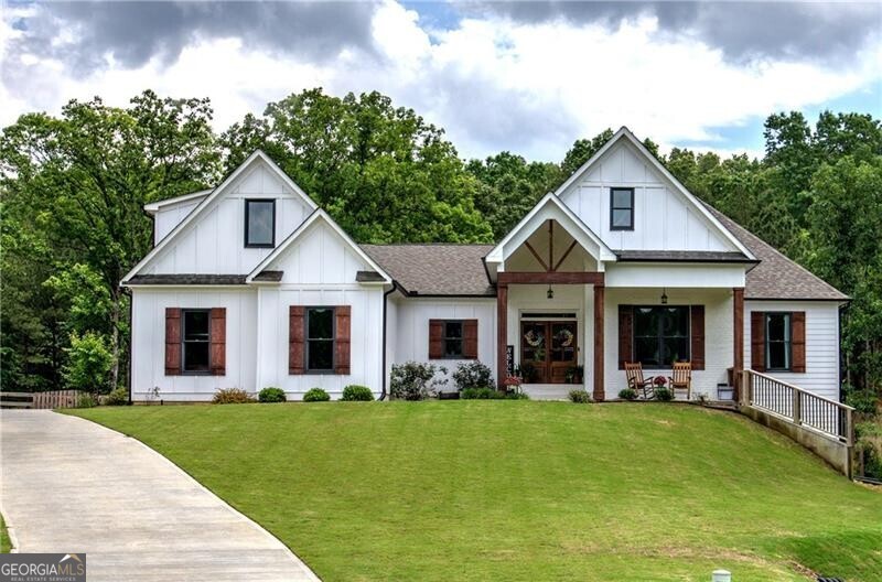 Come Home to Stratford! Step into a lifestyle of comfort and elegance with this stunning 4-bedroom, 3.5-bath Ranch Farmhouse, gracefully situated on 3 lush acres in Stratford Subdivision. From the moment you arrive, this home makes a bold statement welcoming you with a classic rocking chair front porch and timeless white brick exterior, all set in a serene cul-de-sac lot. Grand double doors open into a breathtaking interior where rich hardwood floors, designer lighting, and thoughtful architectural details create a warm yet sophisticated ambiance. The expansive Great Room is brilliant anchored by a magnificent brick fireplace that sets the stage for cozy evenings or stylish entertaining. A true showpiece, the gourmet kitchen is marked for true distinction as it exudes custom cabinetry, sleek quartz countertops, and top-of-the-line black stainless appliances which blend functionality with flair. A striking, oversized island with space for barstools adds an inviting touch, while the immense walk-in pantry offers unmatched storage, microwave sets perfectly inside creating space. Enjoy your morning coffee or casual meals in the light-filled breakfast area, perfectly positioned to capture peaceful and tranquil views of the massive landscape. The luxurious owner's suite is your personal sanctuary featuring a stunning trey ceiling, spa-inspired bath with double vanities, a spacious walk-in subway-tiled shower with dual shower heads, and a generous walk-in closet designed for effortless living. On the opposite side of the home, three additional bedrooms and two beautifully appointed baths ensure privacy and comfort for family or guests. Downstairs, the sprawling unfinished basement with endless possibilities awaits! Create a custom home theater, private gym or the ultimate entertainment space, complete with a reinforced concrete storm room. This exceptional property blends timeless style with modern convenience in a peaceful serene setting. Come home to where elegance, charm, and detail meet peace, tranquility, and beauty. Come home to Stratford! BONUS: ***7-Star 1yr Home Warranty Included!*** Per Public record total square footage includes unfinished basement. Areas are broken out to show finished and unfinished areas.