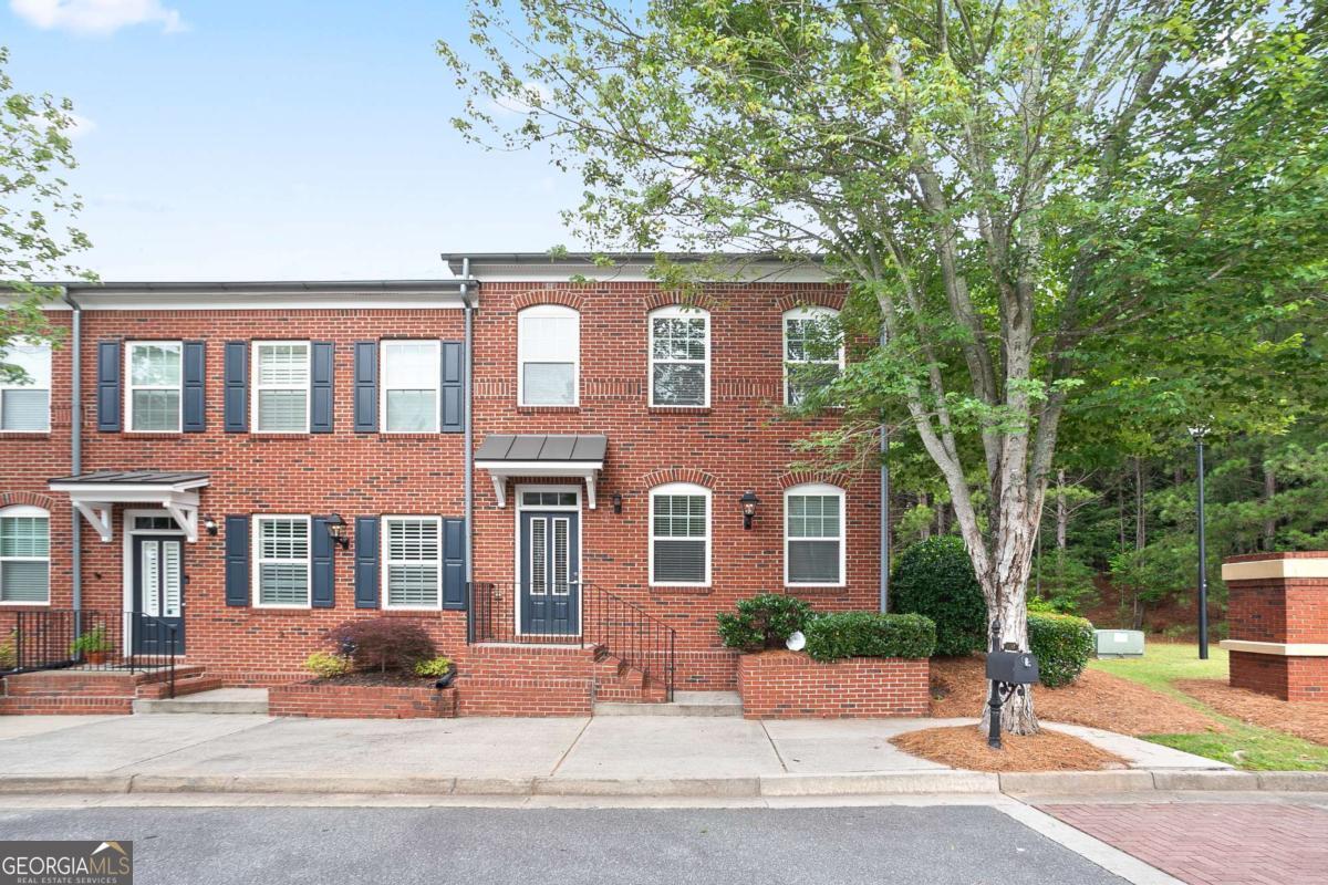 Welcome to this beautifully maintained end-unit townhome with timeless 3-sided brick construction! Nestled in the heart of Suwanee and located in the highly desirable North Gwinnett High School district, this home offers the perfect blend of comfort, style, and convenience. Enjoy easy access to Suwanee Town Center, the Suwanee Greenway, local parks, shopping, and more-all just minutes away. Inside, you'll find gleaming hardwood floors and abundant natural light that fills every room. The spacious living area features a cozy fireplace, while the separate dining room is ideal for hosting family and friends. The kitchen includes a gas range and ample cabinet storage, making meal prep a breeze. Upstairs, the expansive owner's suite includes a generous walk-in closet and a spa-like bathroom with a separate soaking tub and shower. Two additional bedrooms offer versatility for guests, children, or a home office. The HOA takes care of trash pickup, termite protection, exterior maintenance, landscaping, and community pool access-so you can focus on enjoying your home and neighborhood. Don't miss your chance to own this exceptional townhome in one of Suwanee's most sought-after communities!