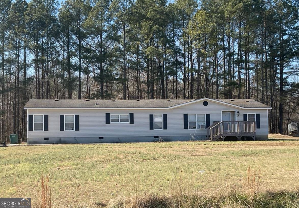 Wonderful opportunity in Gordon County! Nestled on a peaceful 2.02-acre lot, this inviting doublewide home offers the perfect blend of comfort and country charm. Featuring 3 bedrooms and 2 bathrooms, the layout provides plenty of space for relaxed living. Inside, you'll find a warm and welcoming atmosphere-ideal for unwinding after a busy day. Step outside and enjoy the serene country road setting, where tranquility is part of everyday life. The expansive, level yard is well-maintained and ready for your vision-whether that's a flourishing garden, family gatherings, or simply soaking in the open space. Recent updates, including a brand-new roof, new flooring and fresh paint add to the home's appeal. With open land available, you also have the option to build an outbuilding for storage, a workshop, or your next creative project. This home offers the perfect combination of indoor comfort and outdoor freedom-making your dream of country living a reality. Schedule your visit today and explore the endless possibilities!