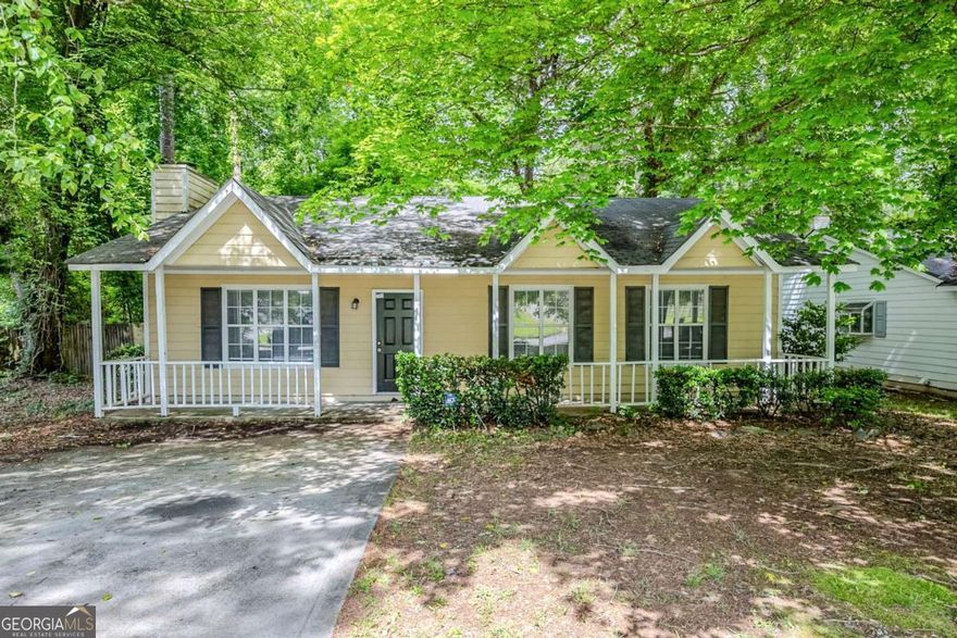 Move-in ready 3-bedroom, 2-bathroom ranch-style home in Lithonia's Marbut Farms neighborhood! Enjoy charming curb appeal with a welcoming front porch perfect for relaxing. Inside, the living room features a cozy fireplace, ceiling fan, and plush carpeting. The kitchen offers dark cabinetry, black appliances, a convenient eat-in counter, and a laundry closet with hookups. A separate dining area opens to the spacious backyard through beautiful French doors-ideal for entertaining. All bedrooms have standard closets, carpeting, and natural light, while the primary suite includes a double closet and private bath with a shower/tub combo. Don't miss the large backyard and private driveway-this home is ready for you! Book your tour today!