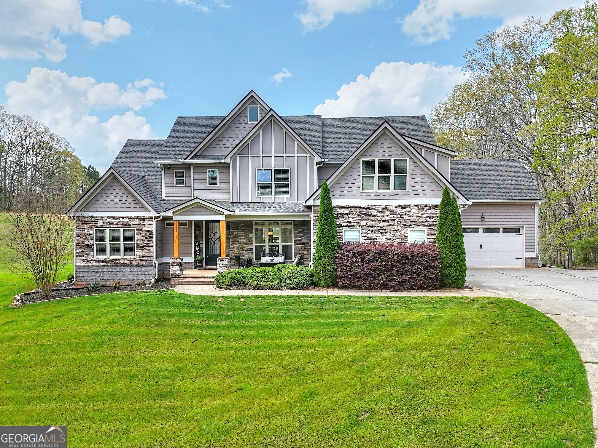 Looking for your perfect hideaway that is located just minutes from town? This custom built home is a STUNNER! Situated on just over 12 acres, this home offers the utmost in comfort, luxury and privacy. Outside you will enjoy the long, private driveway, ample parking space with two 2 car garages on main level. This setting is truly serene! Inside the sellers took no shortcuts in their design decisions from the Oak Hardwood Flooring throughout to the two story family room with stacked stone fireplace, you will be blown away! Beautiful gourmet kitchen with an 8ft Island! Large Primary bedroom and a guest room on main level with an additional three bedrooms upstairs each with their own private bathroom. Need more space? The basement is a blank slate that is plumbed for a kitchen and bathroom ready for your finishing touches! One of the best spaces is definitely the covered back patio with long porch overlooking the beautiful backyard with room for a pool and more! This one is a MUST see! No HOA! EV Charger in garage.