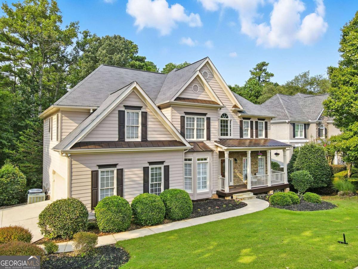 Beautifully situated BridgeMill home less than 1 mile from the main entrance that backs up to Corps of Engineer property and Lake Allatoona. If you enjoy nature and being outdoors, you'll love the ability to walk through the backyard and woods to the lake. Family hikes, fishing at the lake, enjoying the wildlife and nature is one of biggest advantages of this home. Being so close to the BridgeMill entrance you can walk to Publix, restaurants, CVS, banks and even all the amenities that BridgeMill offers, such as the 2 acre resort style pool, playground and sand volleyball courts. You have not even stepped inside the home yet! Upon entering you will find hardwoods throughout the main floor, private office or den, separate dining room, 2 story living room with fireplace, updated kitchen, kitchen nook, bedroom on the main level with full bath, laundry room and spacious rear Trek-style deck overlooking all the beautiful woods. Heading upstairs you will find the oversized primary bedroom with a large bathroom. The primary bathroom has a tile walk in shower, soaking tub, double vanities, double closets and private toilet room. There are 3 additional secondary bedrooms and 1 more full bathroom. That's a lot of house already! Head down to the finished terrace level and you will find ideal entertaining space for games and all sorts of other activities along with a 6th-bedroom and 4th full bathroom, wet bar and access to the large, covered patio with under-deck drainage so it stays dry when it rains. From here you can enjoy the backyard and head into the woods for a walk to the lake. The optional BridgeMill Athletic Club is a resort-style golf, tennis and country club in Canton, Georgia. The Golf Course is semi-private and features an 18-hole championship course with state-of-the-art practice facilities and driving range. The 25-court Tennis Center is one of the largest facilities in the Atlanta area and boasts championship ALTA and USTA teams as well as an outstanding Junior Tennis program. There are also 10 pickleball courts. Two of the most attractive aspects of Membership are Pool and Fitness/Wellness Center usage. The Club's Fitness Center offers commercial gym-quality equipment in a relaxed environment with a full schedule of group fitness classes to fit a wide range of schedules and abilities. Members enjoy fun activities for children as well as adults, ranging from Pool Parties to Dive-In Movies, BBQ's, Holiday Events, Kids' Camps, Playground, Park Area, Pavilion, Sand Volleyball and Basketball Courts.