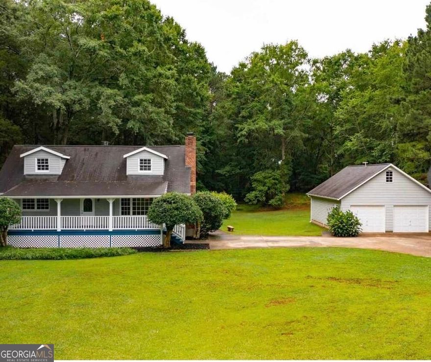 Privacy & Nature - The Best of Both Worlds! Welcome home to this charming rustic retreat nestled on 2 private acres in lovely McDonough, GA! This inviting 3-bedroom, 2-bath home on a full basement offers the perfect blend of tranquility and convenience.  Enjoy quiet evenings on the spacious deck or rocking-chair front porch, surrounded by beautiful wooded scenery. Inside, you'll find a cozy living and dining area ideal for relaxing or entertaining, complete with a wood-burning fireplace for those peaceful Southern nights.  The basement features two finished rooms currently used as a home theater and office, providing flexible space for work or play. A detached 2-car garage offers parking, storage, or the potential to convert into additional living space.  Whether you're dreaming of a cozy home, a place for pets to roam, or simply a serene escape from the city-this property truly has it all!