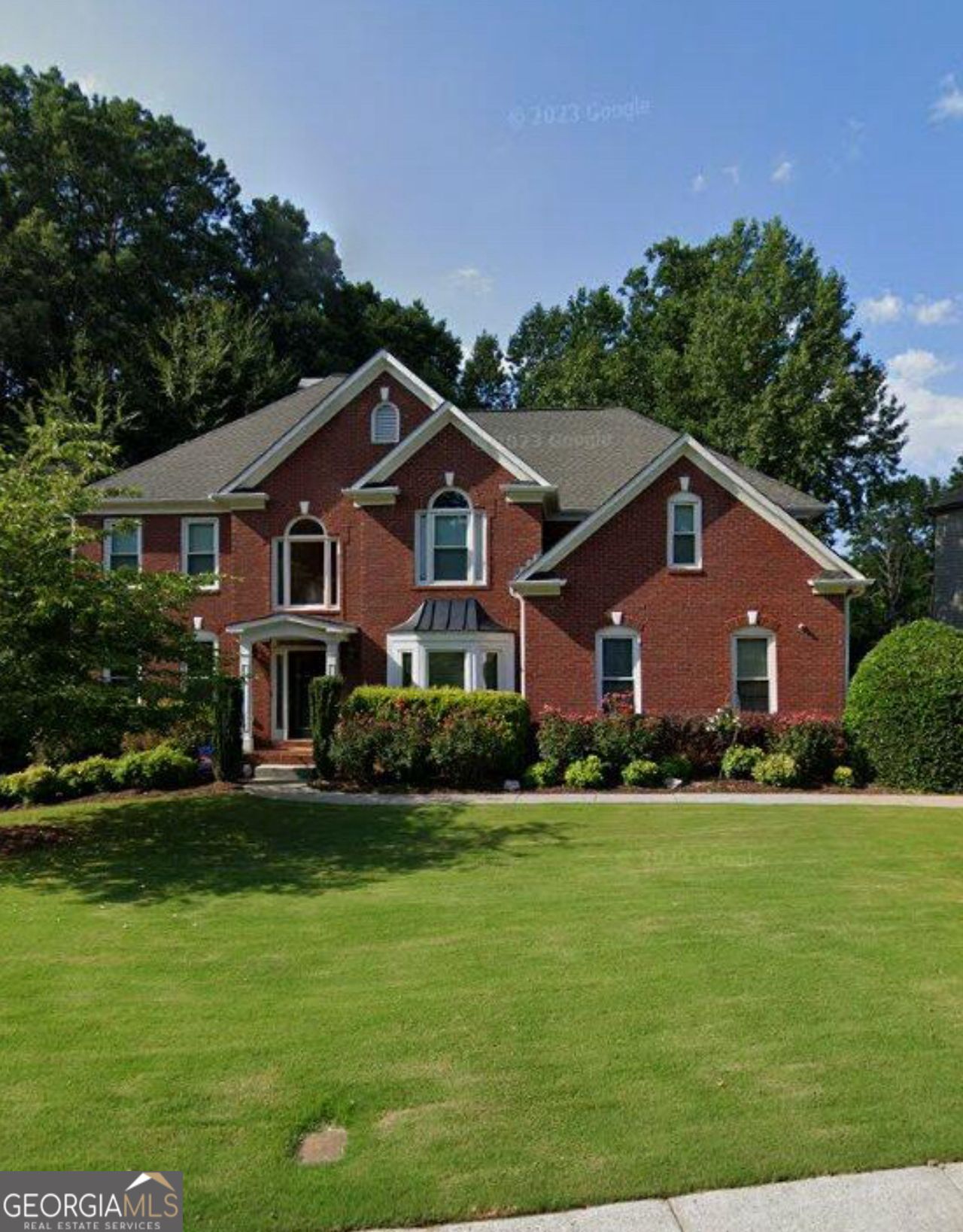 Tucked away in the coveted Lansfaire community and zoned for the award-winning North Gwinnett schools, this beautifully crafted 5-bedroom, 5-bathroom home offers timeless design and thoughtful details throughout. Hardwood floors span the entire home, setting the stage for custom millwork, built-ins, and generous living spaces. The kitchen is a standout-stained custom cabinetry, a sprawling island, granite surfaces, and upscale stainless appliances, including a warming drawer, create both function and style.Enjoy a main-level guest suite, two fireplaces-one in the inviting primary retreat-and the flexibility of a finished basement with space for a 6th bedroom. Step outside to a lushly landscaped, private lot backing to the community lake, complete with a custom deck ideal for entertaining or quiet morning coffee. This is a home that delivers comfort, craftsmanship, and an unbeatable location. Why you should choose this home: its only 4 houses away from pool and amenities, all windows that open have been replaced, every bathroom has custom shower/tub and vanity, NO carpet, HUGE finished basement with endless possibilities, fresh neutral paint, workshop with air system, beautiful private lake lot, and NO City of Suwanee taxes!