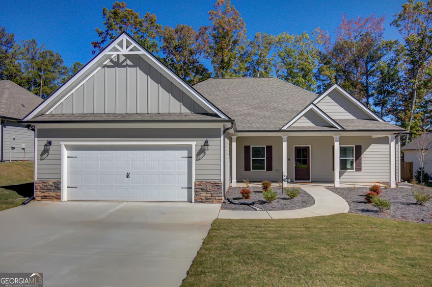 Better Than New! This stunning 4-bedroom 2.5 bath ranch offers modern style, smart design, and beautiful golf course views. The open- concept layout features a spacious kitchen with a huge island and breakfast bar, seamlessly connected to the expansive family room with a cozy fireplace- perfect for entertaining or everyday living.   A flexible 4th bedroom with barn doors just off the kitchen makes an ideal office, playroom or guest space. The primary suite impresses with a stylish accent wall, a spa-like bath with soaking tub, separate tiled shower, and an oversized walk-in closet.   The split bedroom plan offers privacy with two additional spacious bedrooms and a full bath on the oppposite side of the home. The mudroom includes custiom built-in storage and a large laundry area for everyday convenience.   Relax outdoors on the covered back porch overlooking the golf course, and enjoy the garage equiped with a 50-amp EV outlet- ready for your electric vehicle.