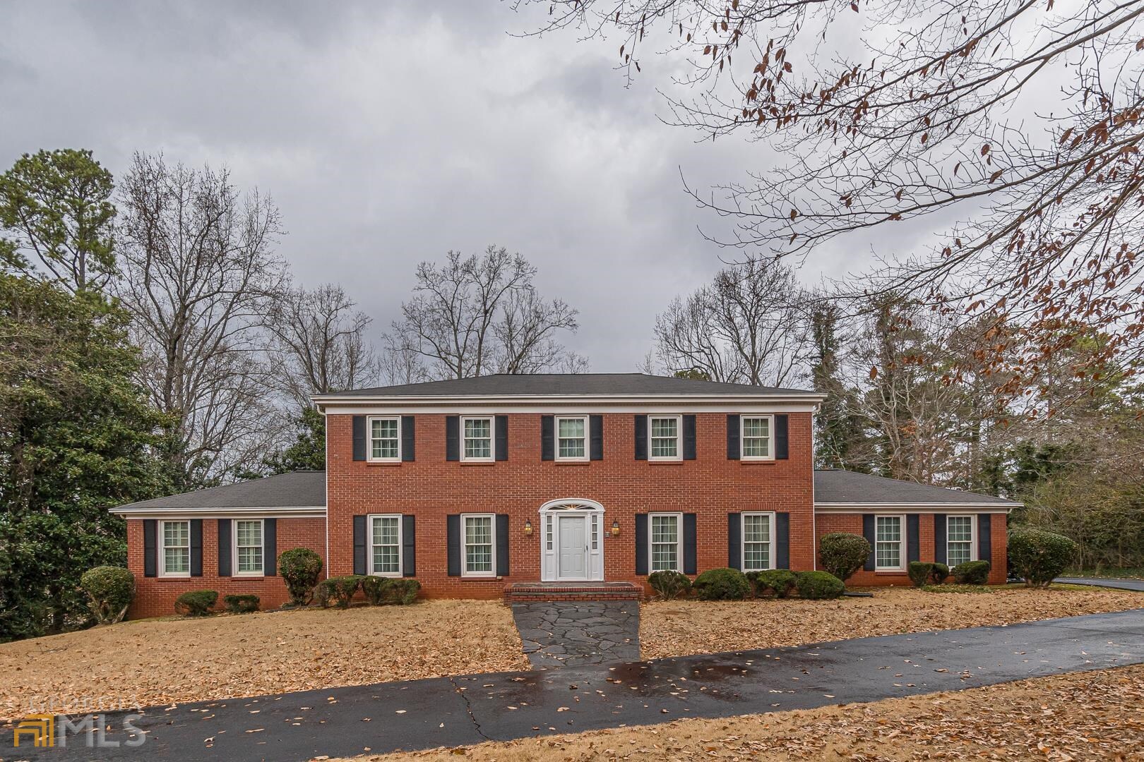 This elegant, red brick traditional home in the prestigious High Point subdivision in Southwest Atlanta, has been extremely well-maintained and is in excellent condition. It's situated on an ideal, gently sloped lot, tucked away on a private, double cul-de-sac street. The Georgian style charmer which features a two-story foyer with the original crystal chandelier and elegant curved stairway with vintage, hand-carved mahogany railing awaits your finishing touches to become a modern classic. A sunny, formal living room and dining room flank the foyer. Straight ahead is a cozy, fireside family room with walnut paneling and shelving. The cheerful, white, kitchen with island and spacious breakfast area opens to a large sunroom with a view to a tranquil backyard filled with flowering trees and shrubbery. The owner's suite is on the main with powder room and primary bath with marble tub and double vanities. You'll find a full basement with a finished bonus room, 4th finished bathroom with walk-in tub/shower, workshop, and plenty of stora678-778-6503ge.