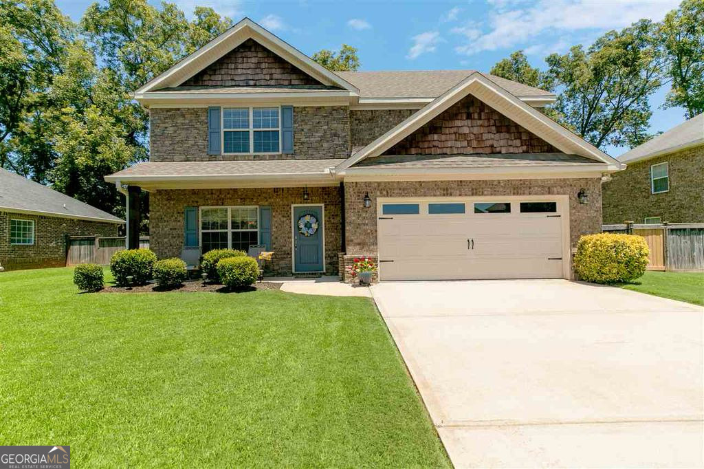 Don't miss out on this: Stunning 4-bedroom, 2.5-bath all-brick home in the highly desirable Kensington Subdivision, offering 2,830 sqft of luxurious living space. This beautifully maintained all brick home features a spacious great room with hardwood flooring and a gas log fireplace, along with a second living area on the main floor-perfect for a home office, den, or playroom. The gourmet kitchen is equipped with stainless steel appliances, abundant cabinet space, and granite countertops. The oversized primary suite boasts plush carpet, a jetted tub, separate tiled shower, and dual vanities. With a new roof installed in January 2025 and new privacy fence August 2025 you can sit back and enjoy the outdoors in your screened-in porch overlooking a beautifully landscaped backyard with a private in-ground pool-ideal for relaxing or entertaining. Convenient location near Robins AFB, I-75, schools, shopping, and dining This one checks all the boxes-schedule your private showing today!
