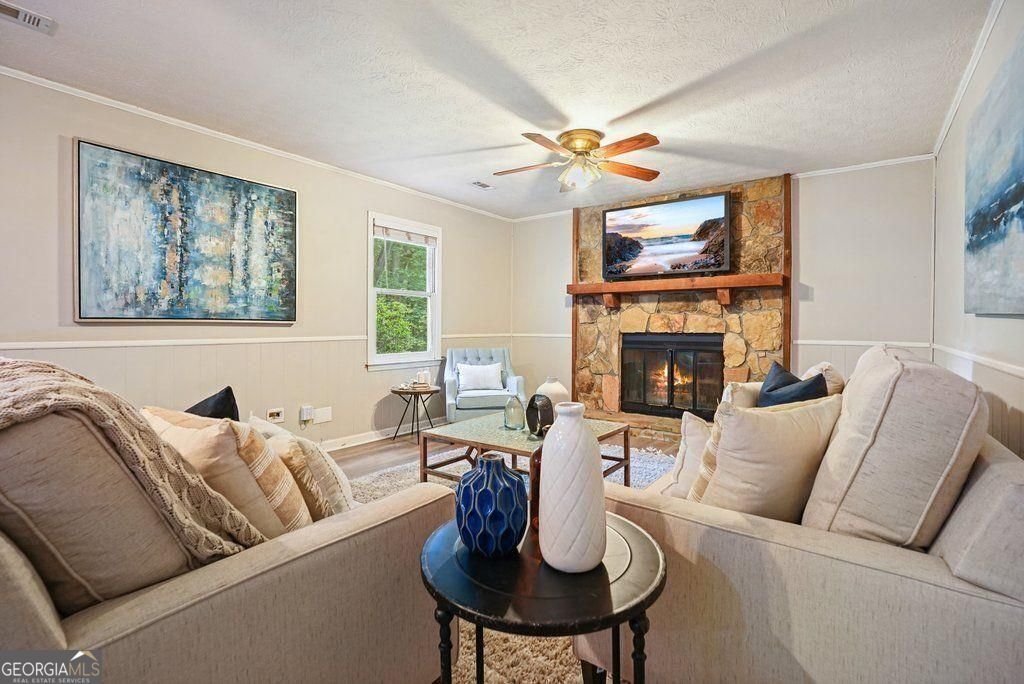 Craving privacy and space to unwind? Are the outdoors calling? Set up your hammock and relax or entertain a crowd on the oversized, freshly painted deck. Let the dogs loose and kids roam and play in the large fenced yard. Enjoy summer evenings on the screen porch and freedom in an established neighborhood with large, level lots, mature landscaping, and no HOA. The big city is minutes away, but you would never know it with the lifestyle and privacy you can find in Mableton! This move-in-ready home welcomes with thoughtful updates where it matters- New floors, fresh interior paint, and an updated master bath has a fresh tile shower and a contemporary and classy flair. The kitchen features a brand-new dishwasher and above-stove microwave (2023). The roof was replaced in 2018, offering peace of mind and long-term durability. With a full living room and family room, a true dining room, four well-sized bedrooms, and two full bathrooms, this home provides ample space for a growing family or multiple work-from-home options. The garage is spacious enough for full-size vehicles AND workbenches. Conveniently located on the border of Smyrna with easy access to everything! Don't miss your chance to own this move-in-ready home with quality updates already completed!