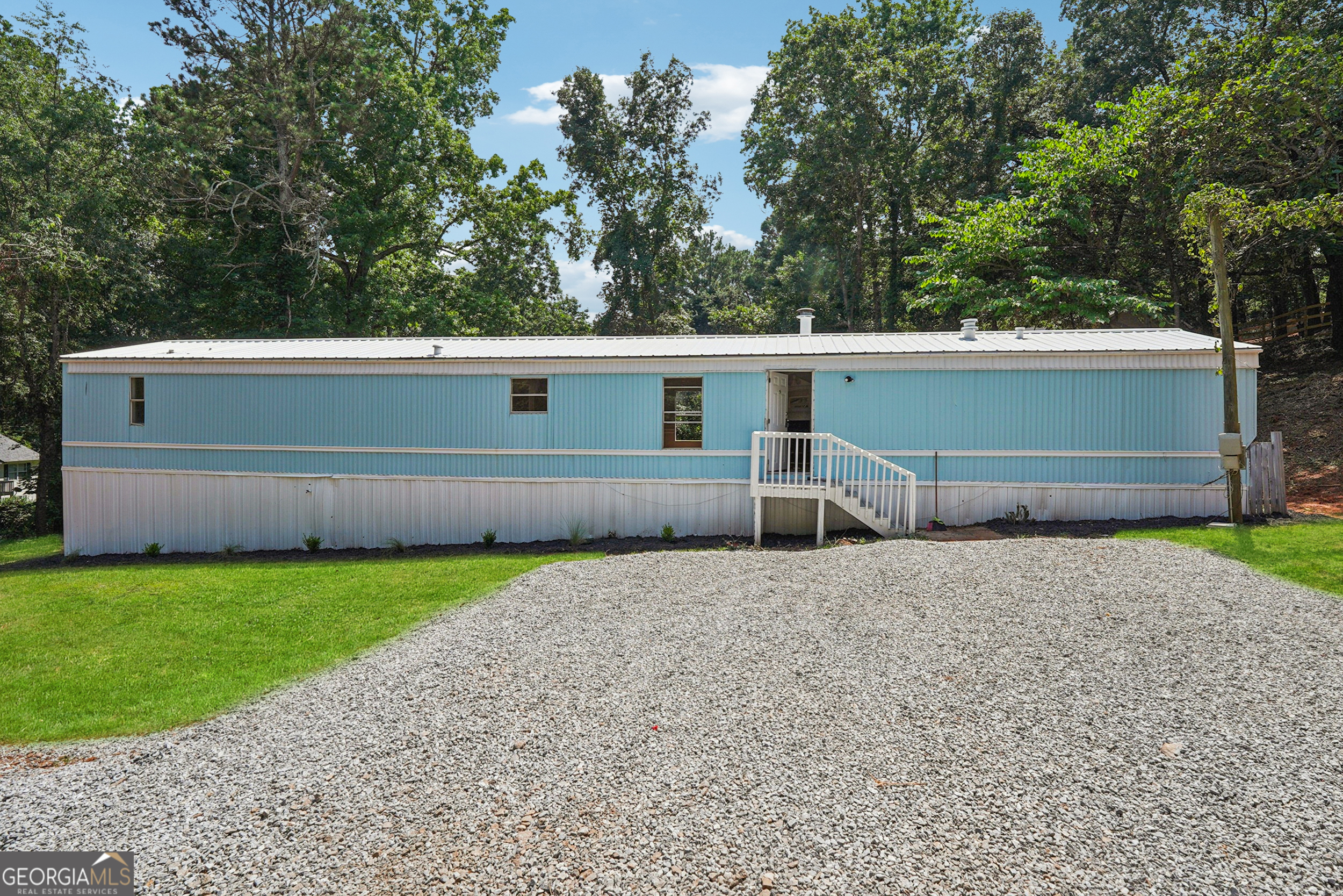 A truly rare find, 4820 Scott Road offers a beautifully updated mobile home sitting on a massive .78-acre double lot (Lot 34 and Lot 35 combined) with extensive road frontage on not just one, but THREE streets-Scott Road, Wisdom Road, and Club Drive-unlocking a world of possibilities. Whether you're envisioning your dream home, an investment rental, new construction, or even a space to store and park equipment, this property delivers unmatched flexibility and opportunity. The large, level lot provides room to expand or repurpose, with no HOA restrictions and endless potential for builders, investors, or owner-occupants. Located in the highly sought-after Forsyth County school district and zoned for the new East Forsyth High School, this is a smart buy in a thriving area with rising property values and high demand. Opportunities like this don't come along often-act fast before it's gone! Home is being sold AS IS-WHERE IS with no disclosures, as the seller has never lived in the home. All due diligence must be completed before submitting an offer. CASH ONLY SALE. Seller does not have the title to the mobile home. SURVEY AVAILABLE