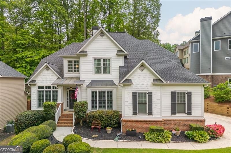 Welcome to this incredible 6 bedroom, 4 full bathroom home spanning three finished levels just one mile from downtown Cumming and the vibrant Cumming City Center! With close proximity to schools, shopping, restaurants and GA400, it's easy to see why Sienna is a highly desirable community. The lush landscaping and beautifully painted white exterior offer extraordinary curb appeal upon entrance to the home. The soaring two story foyer is flanked by a large dining room and main level bedroom currently being used as an office. A full bathroom is also on the main level. The stunning refinished hardwoods lead into the sunken living room with oversized windows offering a cozy vibe for the space. The double sided fireplace in the living room is also enjoyed in the keeping room off the kitchen. The bright white updated kitchen with stainless appliances, center island with seating, and subway tile backsplash feeds to the eating area surrounded by windows. Upstairs, you will find an oversized owner's suite with sitting area. The owner's bathroom has dual vanities, a soaking tub, and large closet! Three additional generously sized bedrooms and a full bathroom are the upper level. The fully finished basement is a true retreat featuring a large bar and huge living area for entertaining! A full bedroom and updated bathroom as well as a large gym complete the space. The back yard has been meticulously landscaped with new sod and professional landscaping. The paver patio with pergola flows right off the kitchen and has a stone countertop with seating for the perfect summer entertaining evenings! This spacious home truly cannot be beat in this location. Come see all that 690 Sienna has to offer!