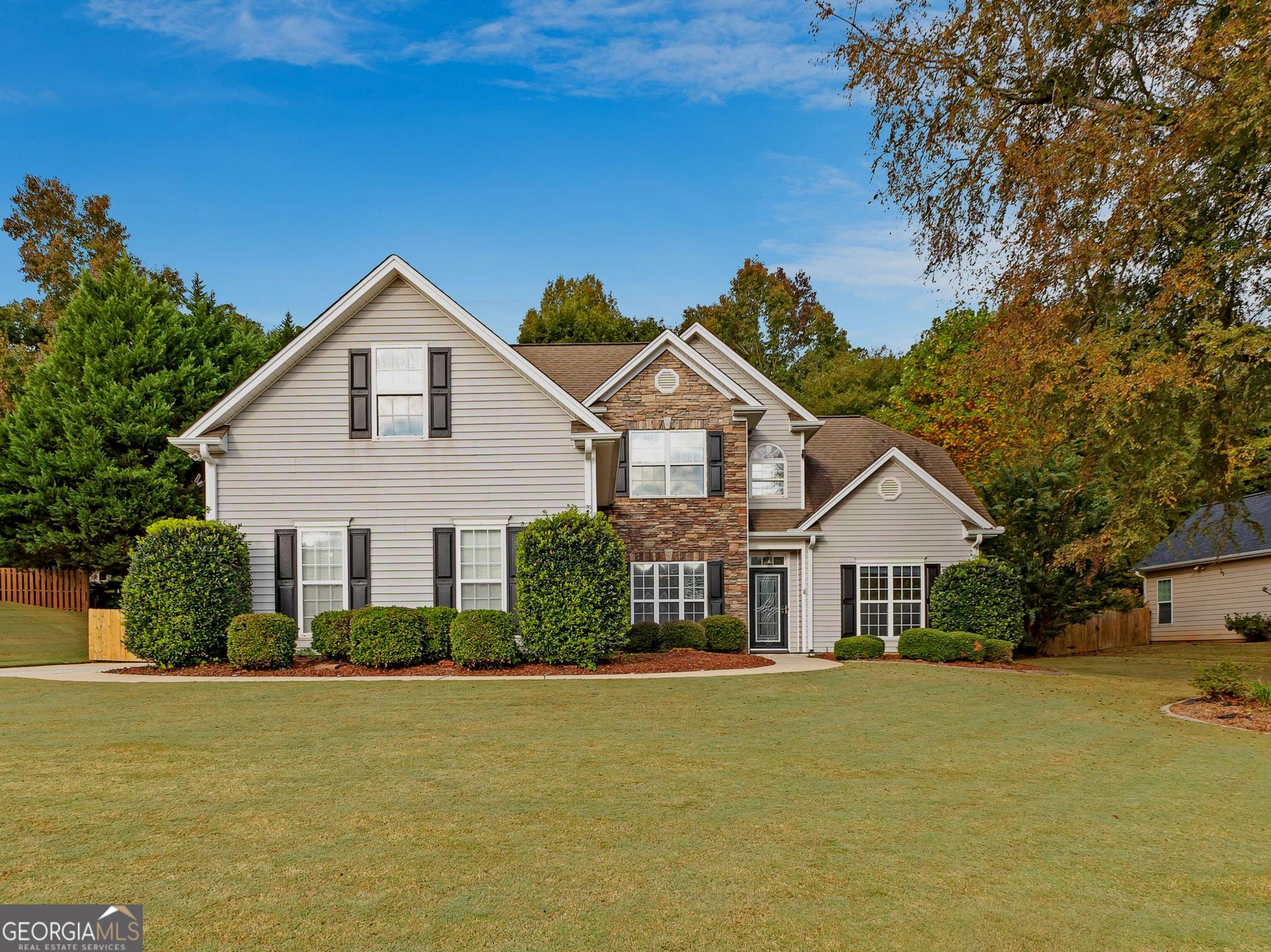 over 3000sq ft, 5-bed, 2.5-bath home features a primary suite on main with a sitting room , a sunroom with windows and AC, A Gazebo for entertaining and a huge flex space upstairs. Step inside and be captivated by the spaciousness and elegance this home offers. The primary bath boasts a double vanity, a rejuvenating soaking tub and a walk-in closet. Upstairs, you'll find four additional bedrooms and another bath featuring a convenient double vanity. Prepare to be wowed by the expansive kitchen, adorned with beautiful granite countertops, ample cabinet space, and plenty of room for culinary creativity. The separate dining room provides the perfect setting for memorable meals with loved ones. Unwind in the inviting family room, featuring a charming fireplace that sets the mood for cozy evenings. The glassed sunroom, adorned with skylights, invites natural light to fill the space, creating a serene atmosphere for relaxation and entertainment. This home also offers hardwood floors and newer carpet. For the hobbyists or DIY enthusiasts, a separate 8x10 shop provides the ideal space to bring your projects to life. Step outside into your personal oasis an enchanting retreat-like backyard awaits. Delight in the soothing koi fish pond or spend time with friends and family in the gazebo, creating memories to last a lifetime. The meticulously maintained grass, is complimented by a sprinkler system. Efficiency and comfort are paramount, with high-efficiency HVAC ensuring a pleasant climate year-round. The attic blanket reduces heat transfer, further enhancing energy efficiency and reducing utility costs. Don't miss the opportunity to make this remarkable house your home. Schedule a showing today and experience the perfect blend of convenience and comfort.