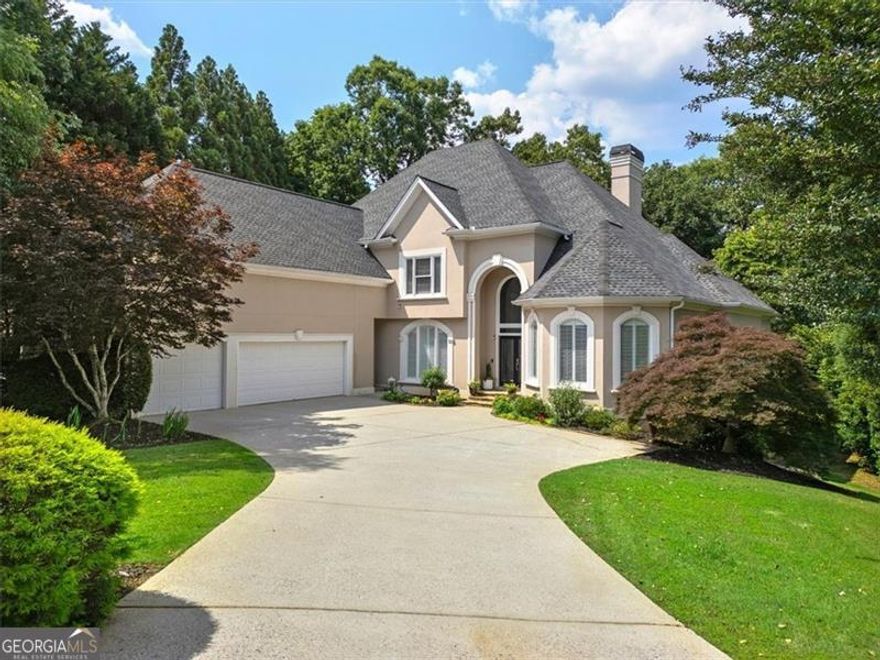 Welcome to your dream home in the coveted Falls at Autry Mill neighborhood of Johns Creek! This open and bright residence is move-in ready and exudes model home appeal. The master suite is conveniently located on the main level, featuring a luxurious spa bathroom that has just been renovated, along with an expansive walk-in closet.  The heart of the home is the spacious keeping room kitchen, a chef's dream equipped with a warming drawer, double ovens, and stainless steel appliances. The kitchen also includes an eat-in area with a charming turret and a large sitting area, a butler's pantry, several additional pantries, a home office, and a laundry room.  Upstairs, you'll find giant secondary suite-like bedrooms with fresh paint and brand new carpet, offering ample space and comfort. Enjoy the convenience of a laundry chute connecting these two large bedrooms to the main floor laundry room. Originally designed with five bedrooms and three baths upstairs, the layout has been thoughtfully reimagined to create two suite-like rooms with walk-in closets and full bathrooms.  The outdoor space is a private oasis, boasting a huge backyard with a stunning waterfall, a play area, a paver patio, and plenty of room to add a pool. It also includes a built-in gas line for your grill, making outdoor cooking a breeze. The finished terrace level, with beautiful new floors, is perfect for entertaining and includes a den, game room, and potential in-law suite, along with three unfinished areas for storage or customization.  This home is equipped with modern conveniences such as security cameras, surround sound, a generator hookup, and built-in speakers throughout. The property also features a refreshed landscape with a pond and lower stone patio, stained deck, and one of the largest fenced yards in the neighborhood.  Additional features include a sprinkler system, a home alarm with two Ring cameras and three ADT Pulse cameras, and keyless front door entry. This home is a masterpiece of design and functionality in the sought-after Falls at Autry Mill. The Falls of Autry Mill provides unmatched amenities: 11 newly renovated tennis/pickleball courts, a grand clubhouse, three pools, a competitive swim team, and a fitness center. With top-rated schools just minutes away, this community is perfect for families. Don't miss the chance to call this stunning property your own!