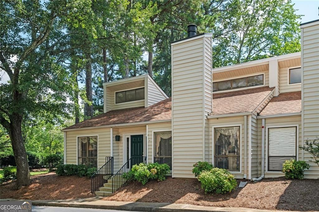 Welcome to easy, one-level living in this unique 2-bedroom, 2-bathroom patio home condo, tucked away in a quiet, friendly swim/tennis community in East Cobb. Zoned for Sope Creek Elementary, Dickerson Middle, and Walton High, this home offers access to Cobb County's top-ranked schools-plus the added benefit of low senior taxes. Originally built as a 3-bedroom, the layout was thoughtfully customized to feature a larger kitchen with a keeping room and eat-in area, ideal for both everyday living and entertaining. Inside, you'll find an expansive great room with a soaring vaulted ceiling, abundant natural light, and a dramatic floor-to-ceiling stone fireplace-a true focal point of the home. The kitchen boasts a center island, stainless steel appliances, ample cabinetry, and opens into a warm and inviting keeping room. The primary suite features its own vaulted ceiling, generous proportions, and a full en-suite bath. A new HVAC system provides comfort and peace of mind year-round. Step outside to your private, fenced courtyard, perfect for morning coffee, gardening, or quiet evenings under the stars. A two-car carport with just one step into the kitchen makes grocery trips from Parkaire Kroger effortless. This is a rare opportunity to enjoy low-maintenance, single-level living in one of East Cobb's most desirable communities. Don't miss it!