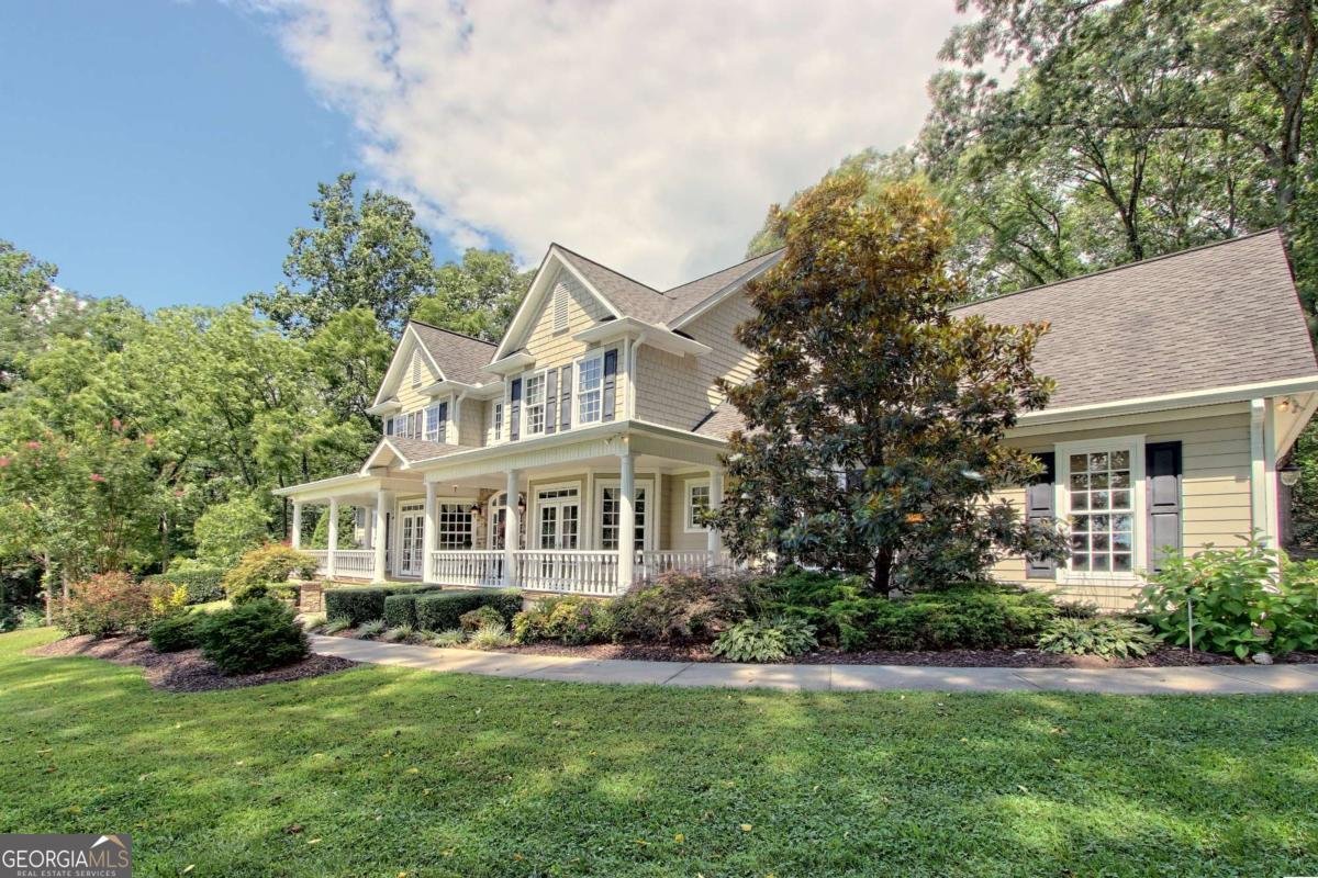 Experience luxury living on 13.14 acres of fully usable land with this stunning 5-bedroom, 4.5-bath custom-built home. From the moment you step inside, the craftsmanship shines featuring an absolute chef's kitchen with granite countertops, custom cherry cabinetry and an open layout that flows seamlessly to both the eat-in breakfast area and elegant dining room. The spacious living room centers around a striking stone gas-log fireplace, creating a warm, inviting atmosphere. The main-level owner's suite offers comfort and convenience, as does the main-level laundry. Upstairs, you'll find a loft area, three spacious bedrooms, two full baths, a bonus room, and abundant storage perfect for family, guests, or hobbies. The attached two-car garage provides easy access and additional storage space. Downstairs, the fully finished terrace level is practically a home of its own complete with a full kitchen, great room, media room, office, bedroom, and full bath perfect for a mother-in-law suite or guest retreat, with its own private entrance. Outdoors, enjoy a covered porch on the front and back of the home, a picturesque pond, a branch that flows around the property, and a 30x30 barn with a garage, half bath, and generous storage. Whether you're seeking space for hobbies, entertaining, or simply enjoying nature, this property delivers it all and so much more.