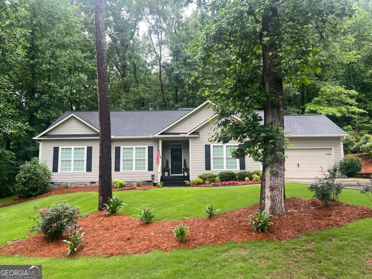 Welcome to this beautifully maintained 3-bedroom, 2-bathroom ranch-style home located in a quiet, desirable area of Marietta-with no HOA restrictions! Featuring a spacious open floor plan, this home offers comfort, functionality, and modern touches throughout. The inviting family room centers around a cozy fireplace, perfect for relaxing or entertaining. Just off the family room, you'll find a large kitchen complete with a generous island, ideal for meal prep, casual dining, and hosting guests. The spacious owner's suite is tucked away for privacy and includes a large en-suite bathroom with dual vanities, a separate shower, and a large closet with ample storage. Two additional secondary bedrooms provide plenty of space for family, guests, or a home office, and are conveniently located near a full guest bathroom. A dedicated laundry room adds extra convenience and storage. With one-level living, no HOA, and a prime Marietta location, this home offers the perfect blend of comfort, freedom, and accessibility.